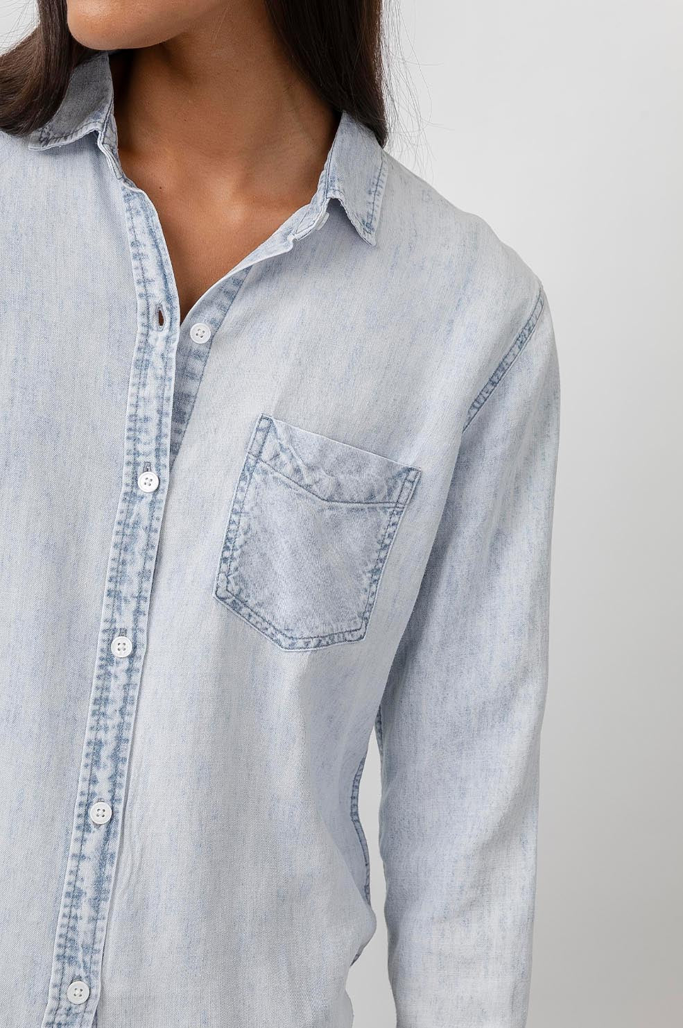Ingrid Raw Hem, Long Sleeve Denim Button Up with a Chest Patch Pocket in Light Acid Wash Colorway - Front View Featured on Model