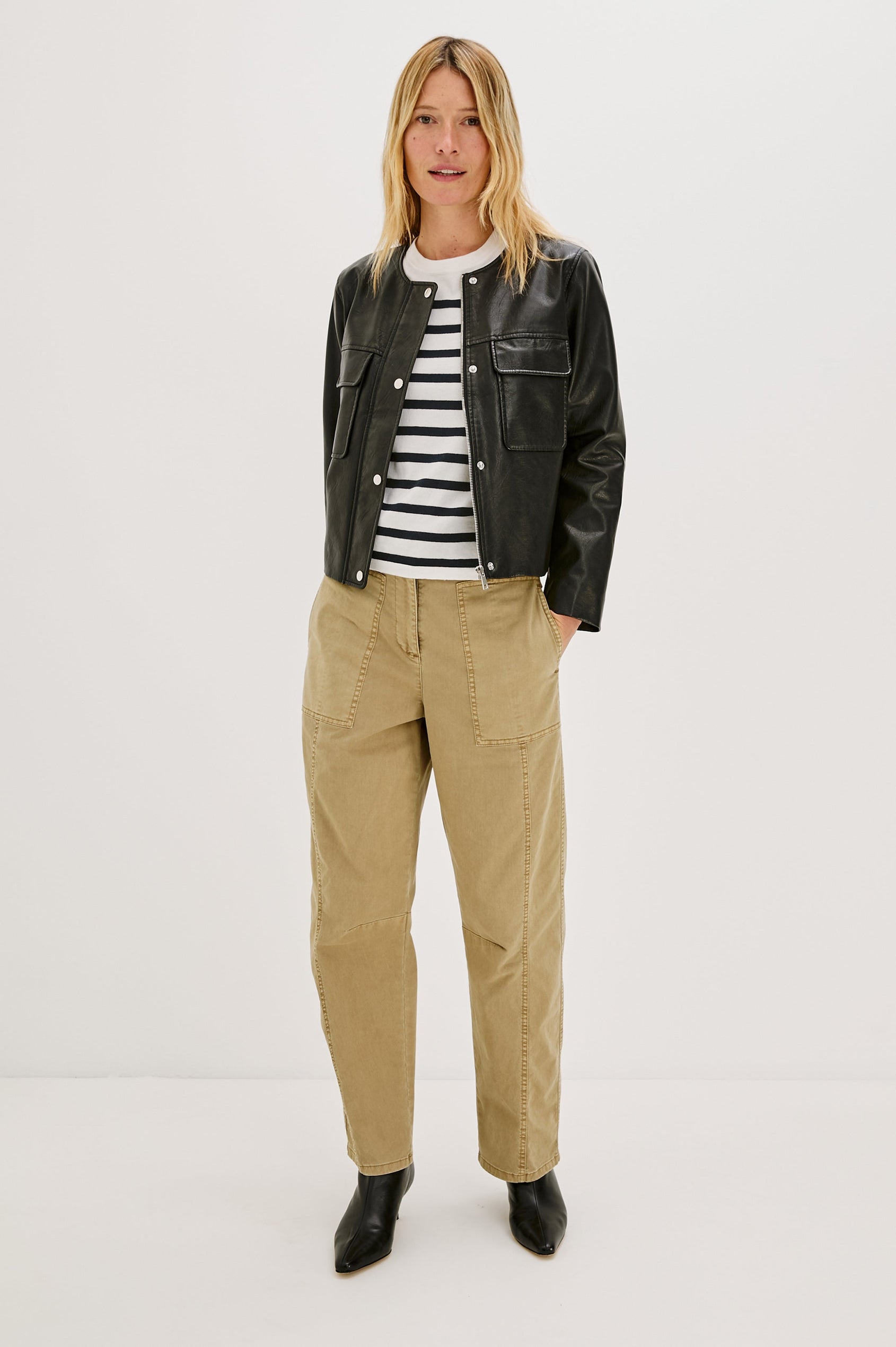 Inka, a cropped, boxy faux leather jacket in a black, slightly distressed finish. The design includes classic chest pockets and a structured silhouette. Full Body Front View featured on model, Unzipped