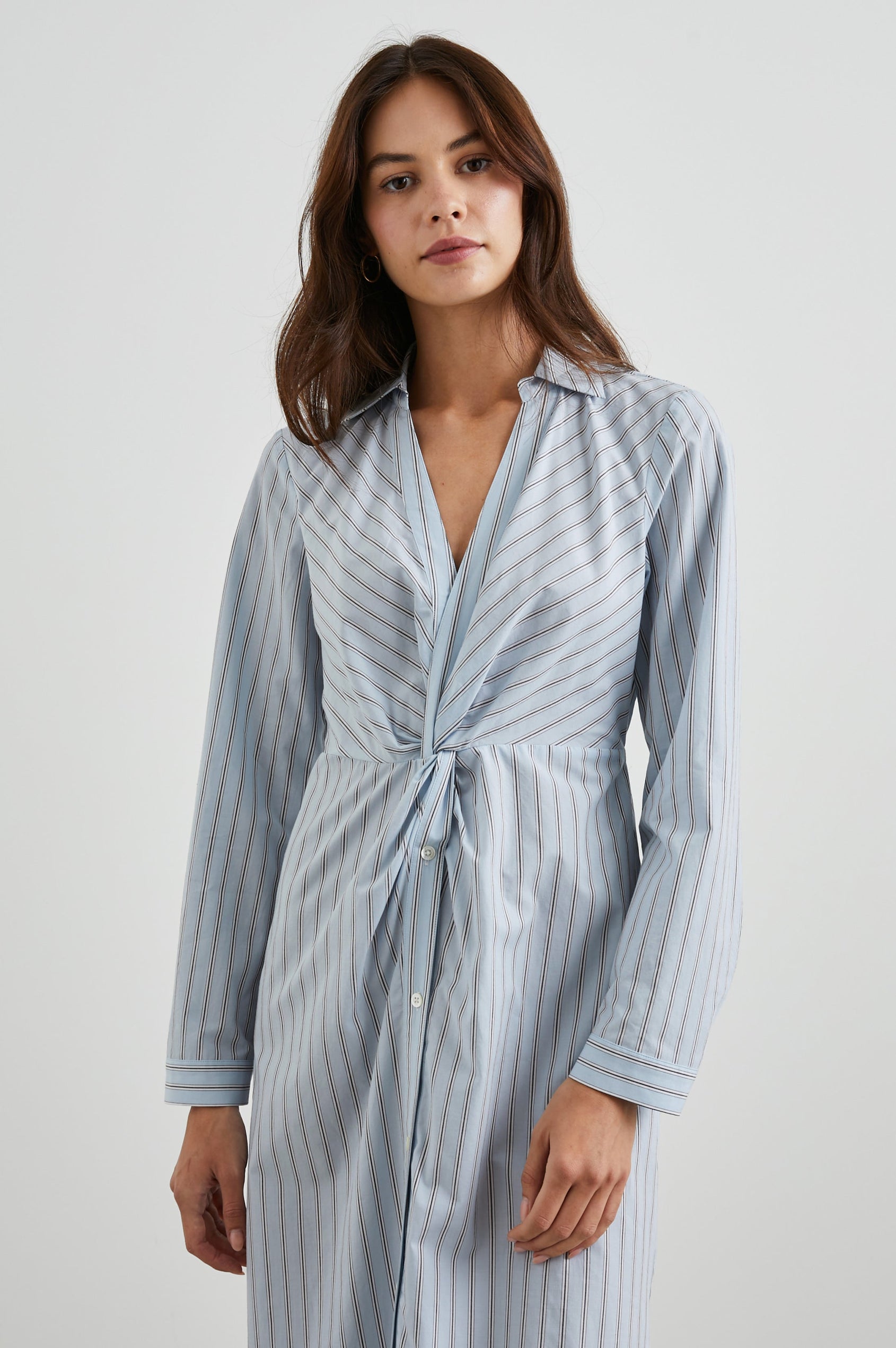 Irie Long-Sleeve Midi Dress with an Overlapped V Neck, Buttons Down the Skirt, a Side Thigh Slit, a Collar and a Seam at the Waist in Hampton Stripe Colorway, Black and White Diagonal and Vertical Stripes on Light Blue - Front View Featured on Model 