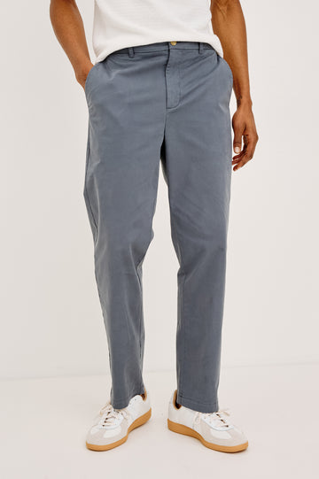 Irving Slim Straight Pant With Side Slant Pockets and Back Welt Pockets in Ensign Blue Colorway - Lower Body Front View Featured on Model