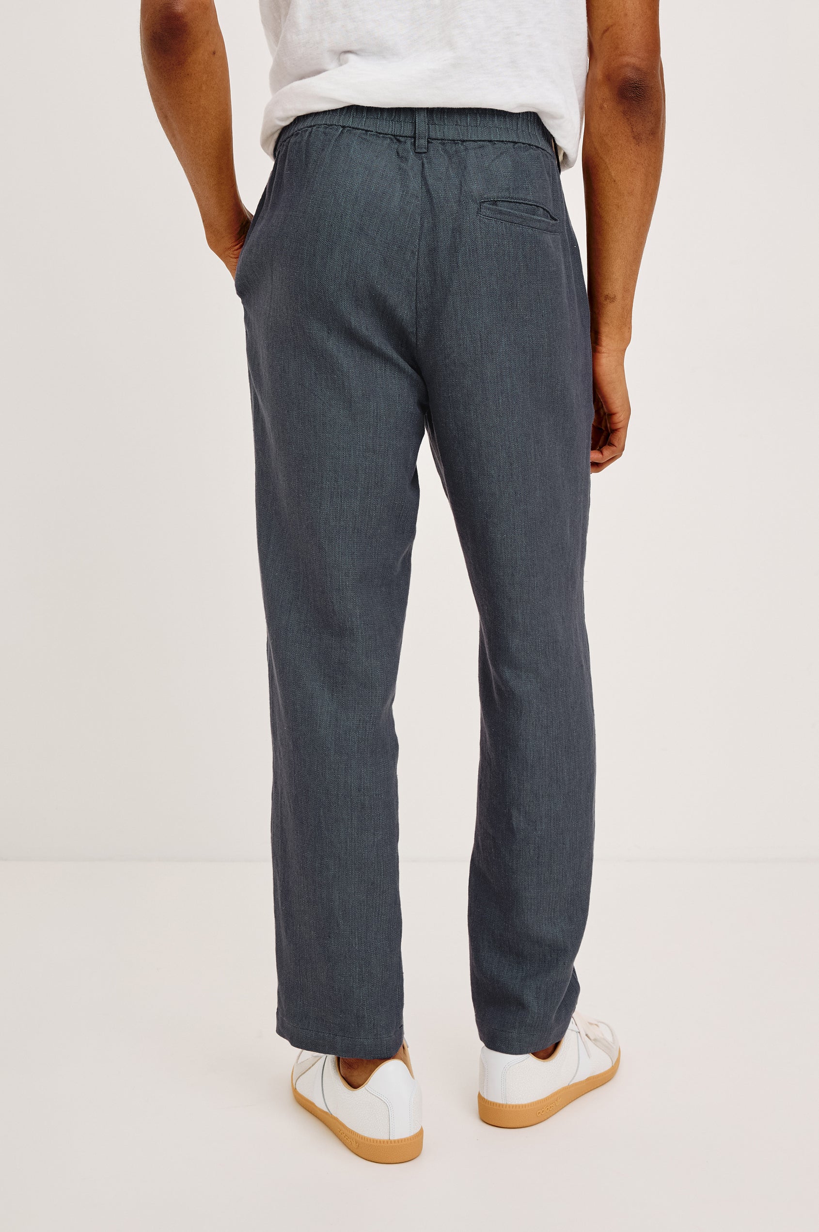 Irving Slim Straight Pant With Side Slant Pockets, and Back Welt Pockets in Meridian, a blue Colorway - Back View Featured on Model