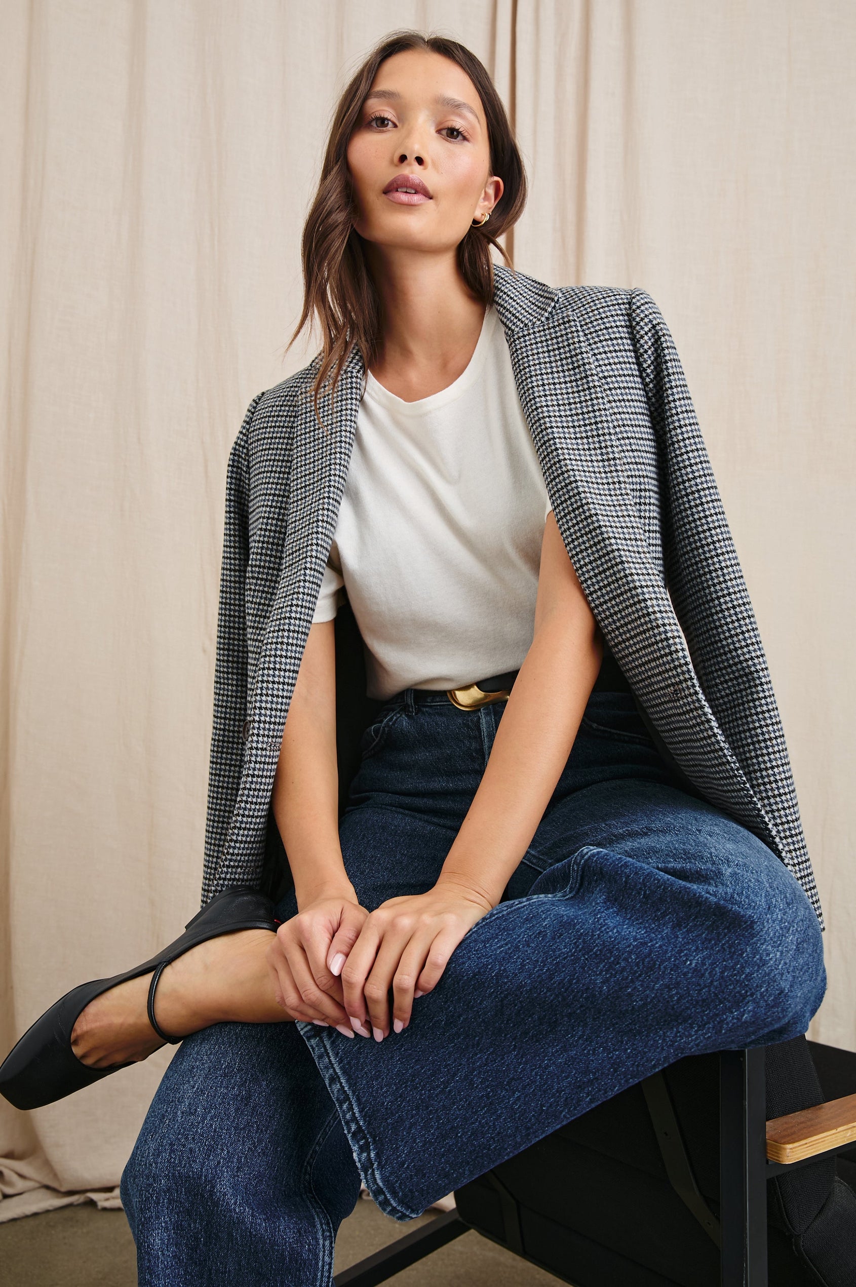 Jac Double-Breasted Blazer with Two Front Flap Pockets and a Notched Label in Black Lapiz Colorway, Houndstooth with black, blue, brown and cream - Front Full Body View Featured on Seated Model