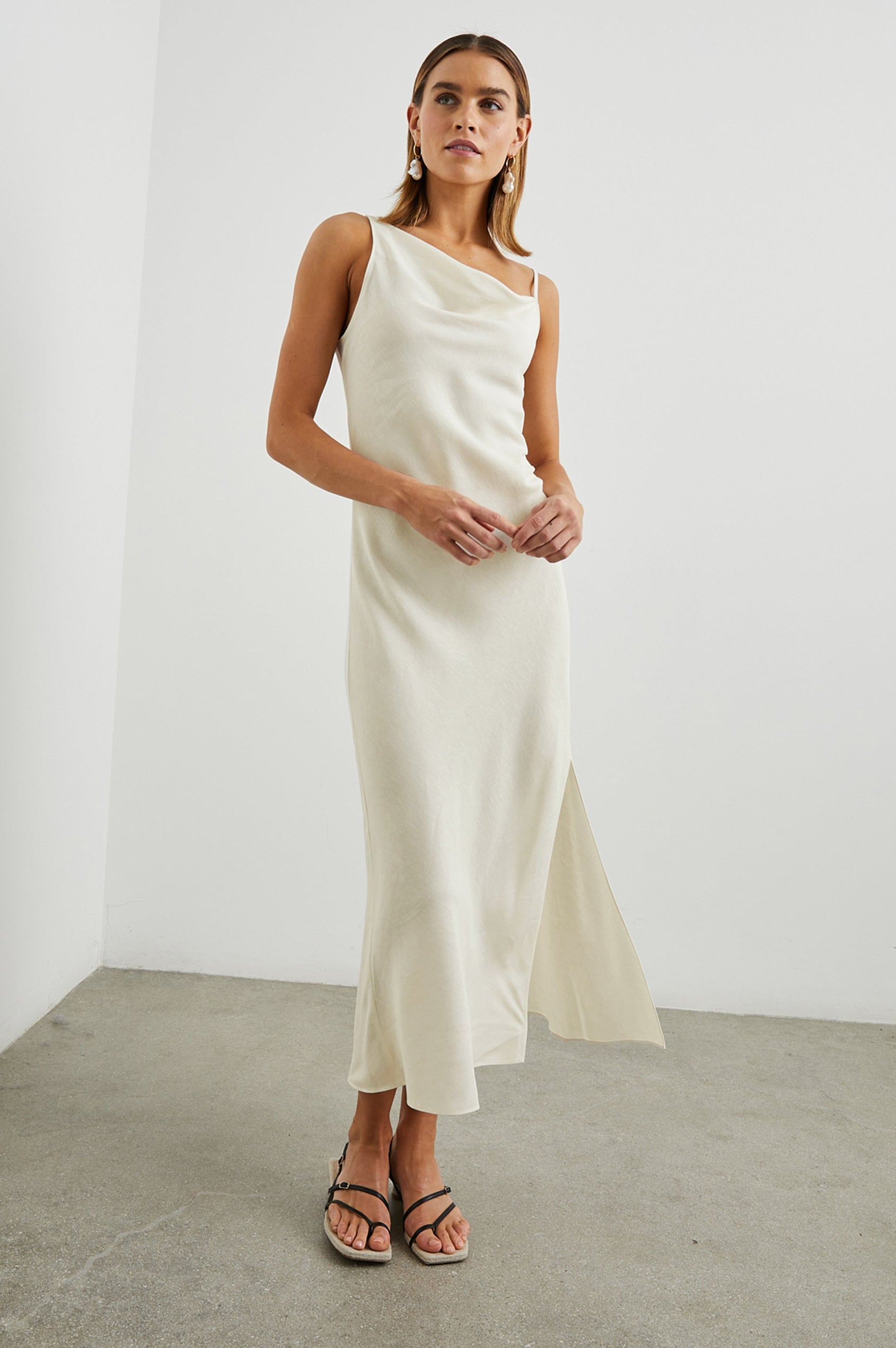 Lotus Sleeveless Midi Dress with an Asymmetrical Cowl Neck, Adjustable Back Spaghetti Straps, a Side Slit, Light Ruching on one Bodice Side in Lotus Colorway - Front Full Body View Featured on Model