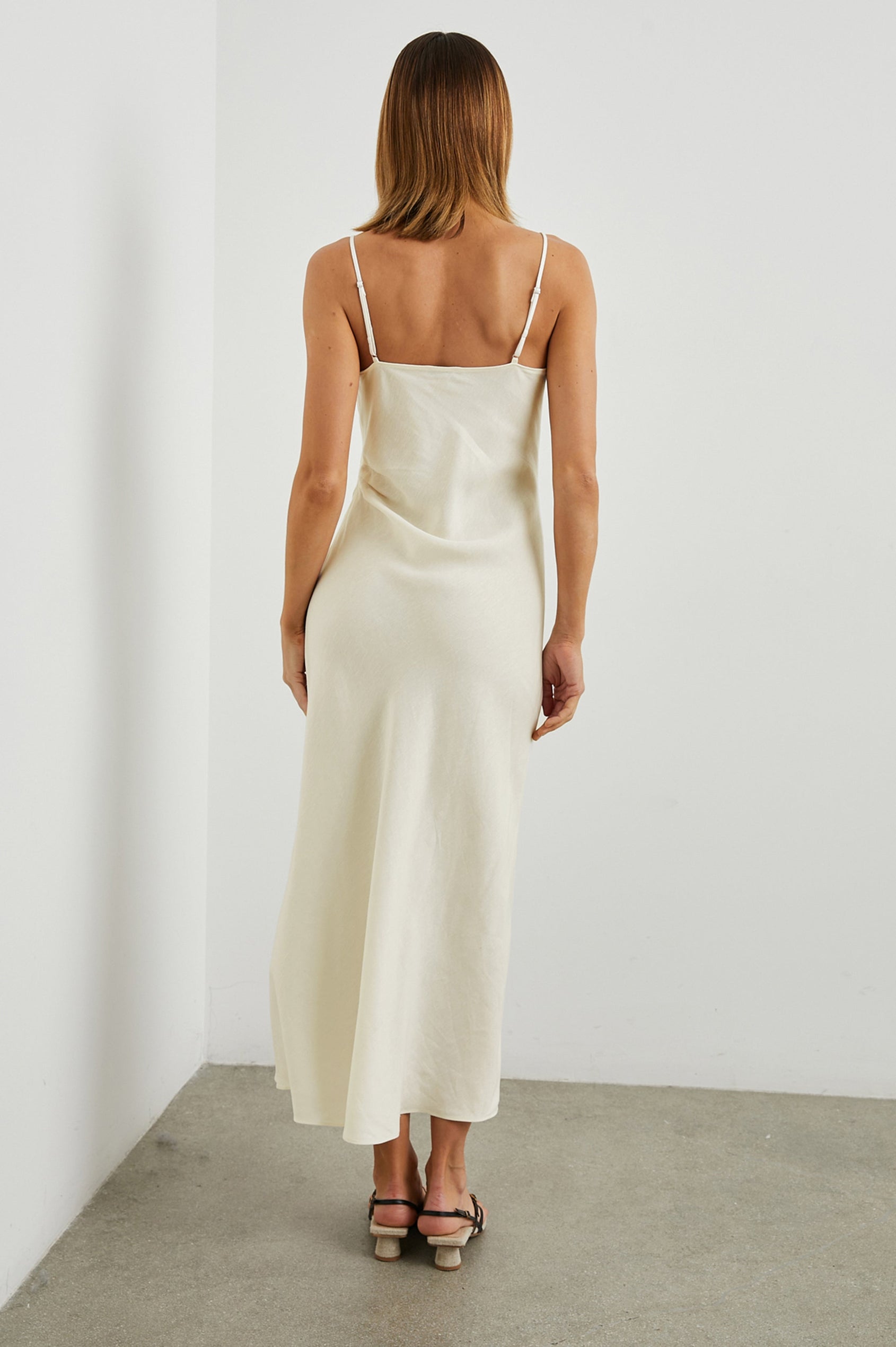 Lotus Sleeveless Midi Dress with an Asymmetrical Cowl Neck, Adjustable Back Spaghetti Straps, a Side Slit, Light Ruching on one Bodice Side in Lotus Colorway - Back Full Body View Featured on Model