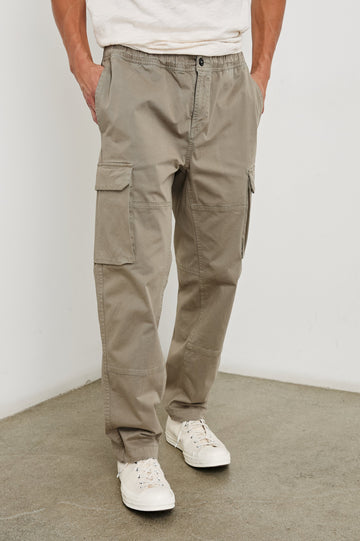 Jaiden Pants with an Elastic, Button Waist with Zip Fly, Two Front Pockets, Two Side Flap Pockets, and Two Back Flap Pockets in Barley Colorway - Front View Featured on Model
