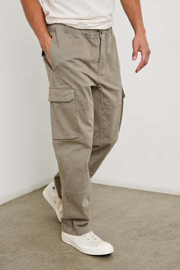 Jaiden Pants with an Elastic, Button Waist with Zip Fly, Two Front Pockets, Two Side Flap Pockets, and Two Back Flap Pockets in Barley Colorway - Front View Featured on Model