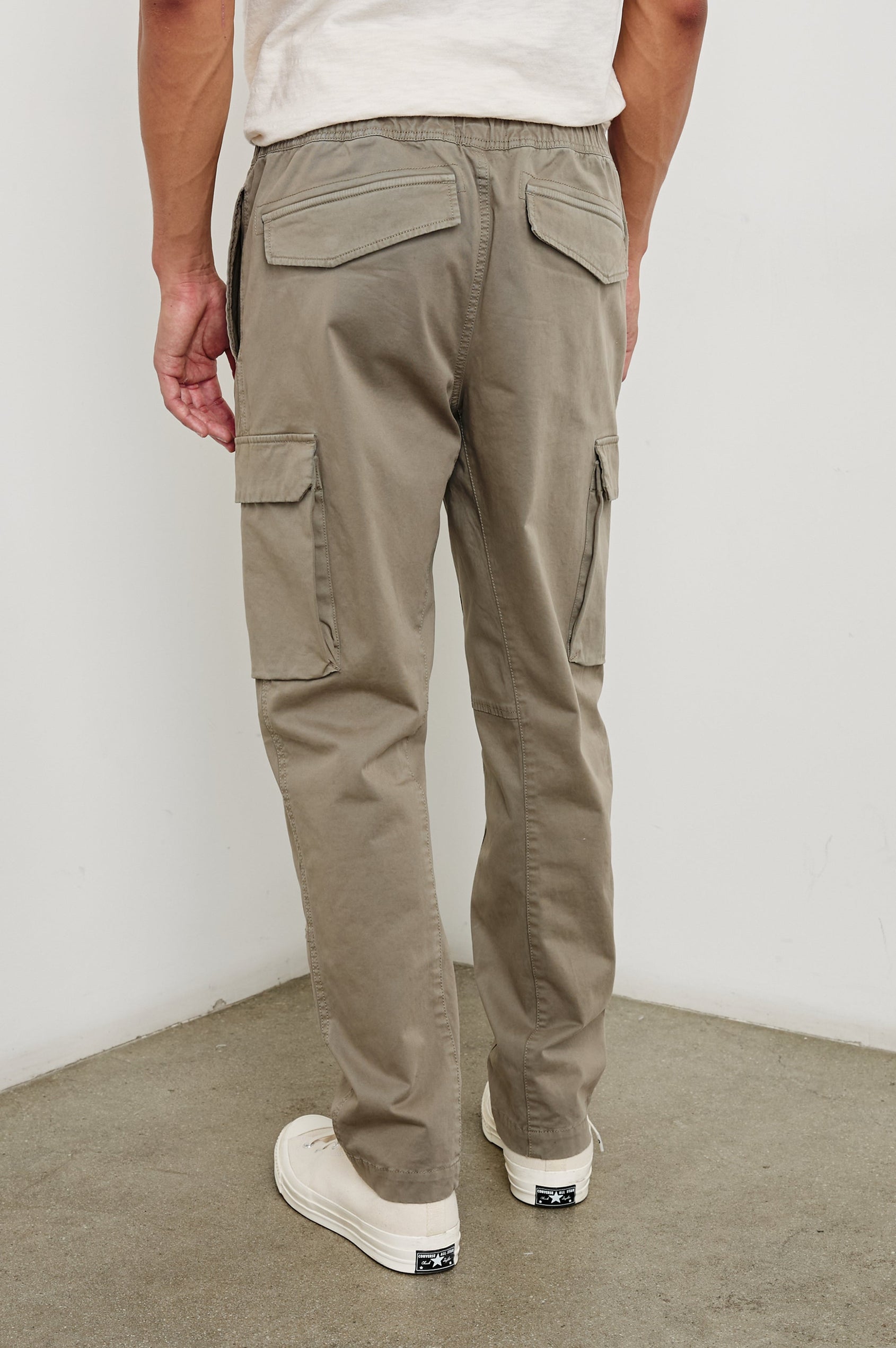 Jaiden Pants with an Elastic, Button Waist with Zip Fly, Two Front Pockets, Two Side Flap Pockets, and Two Back Flap Pockets in Barley Colorway - Back View Featured on Model
