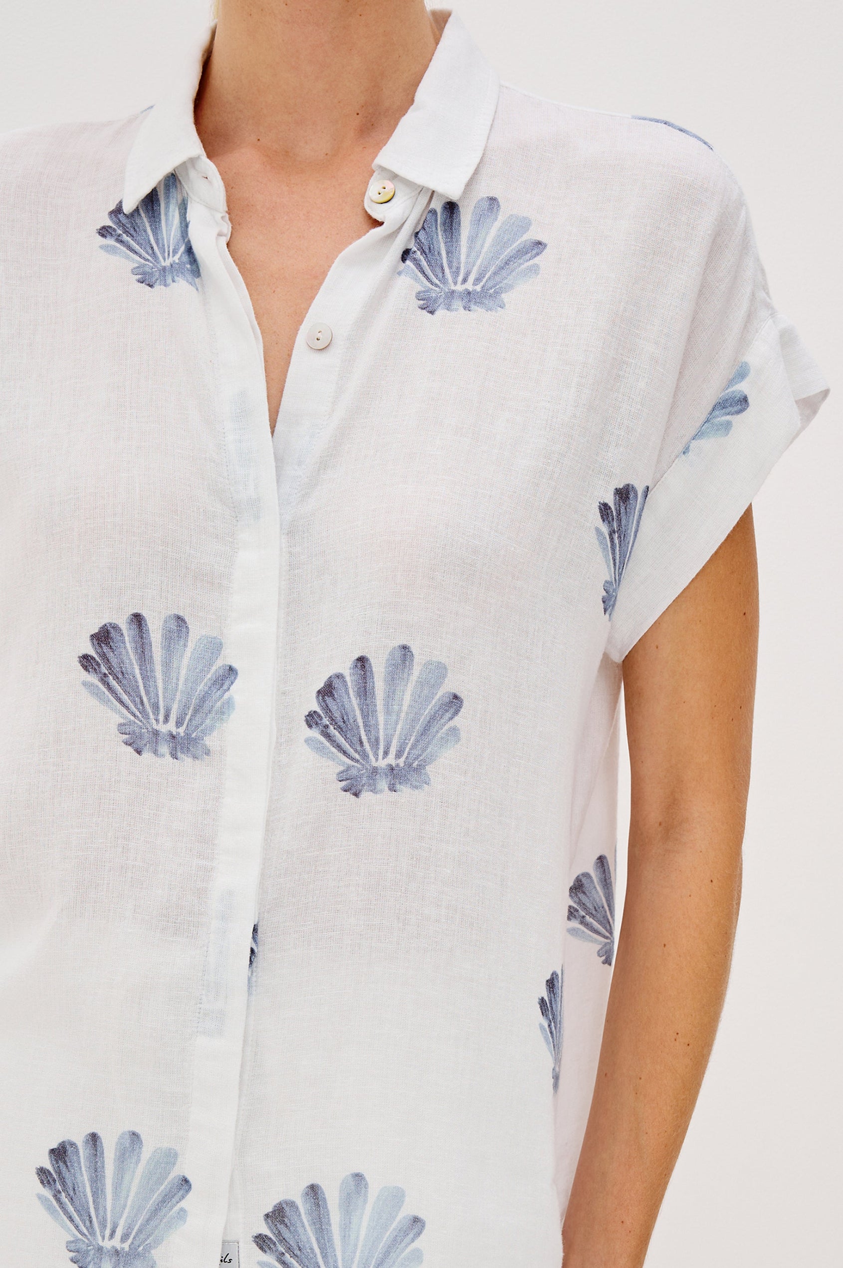 Jaime Collared Button Front Shirt with Short Cuffed Sleeves and Blue Seashells Colorway. Front Detailed View Shown on Model. 