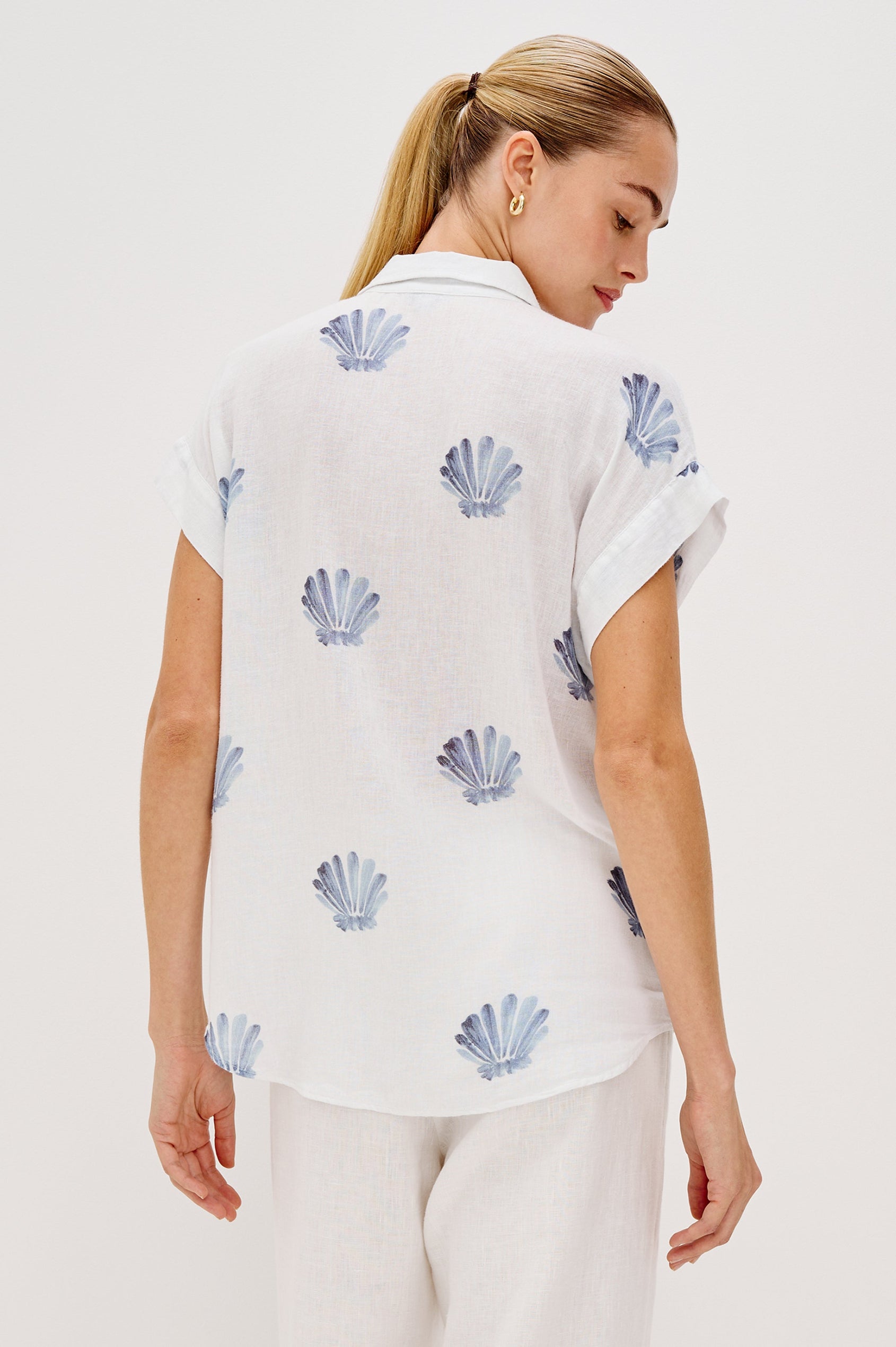 Jaime Collared Button Front Shirt with Short Cuffed Sleeves and Blue Seashells Colorway. Back View Shown on Model. 