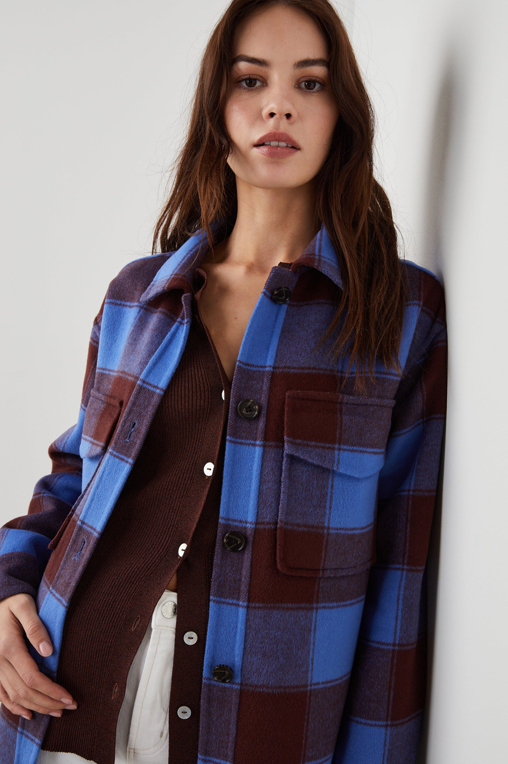 Jaro Mid-Thigh Length Coat with Button Closure, Button Cuffs, Two Chest Flap Pockets, Two Front Pockets and Side Hem Slits in Cobalt Chocolate Colorway, a Plaid - Front View Featured on Model 