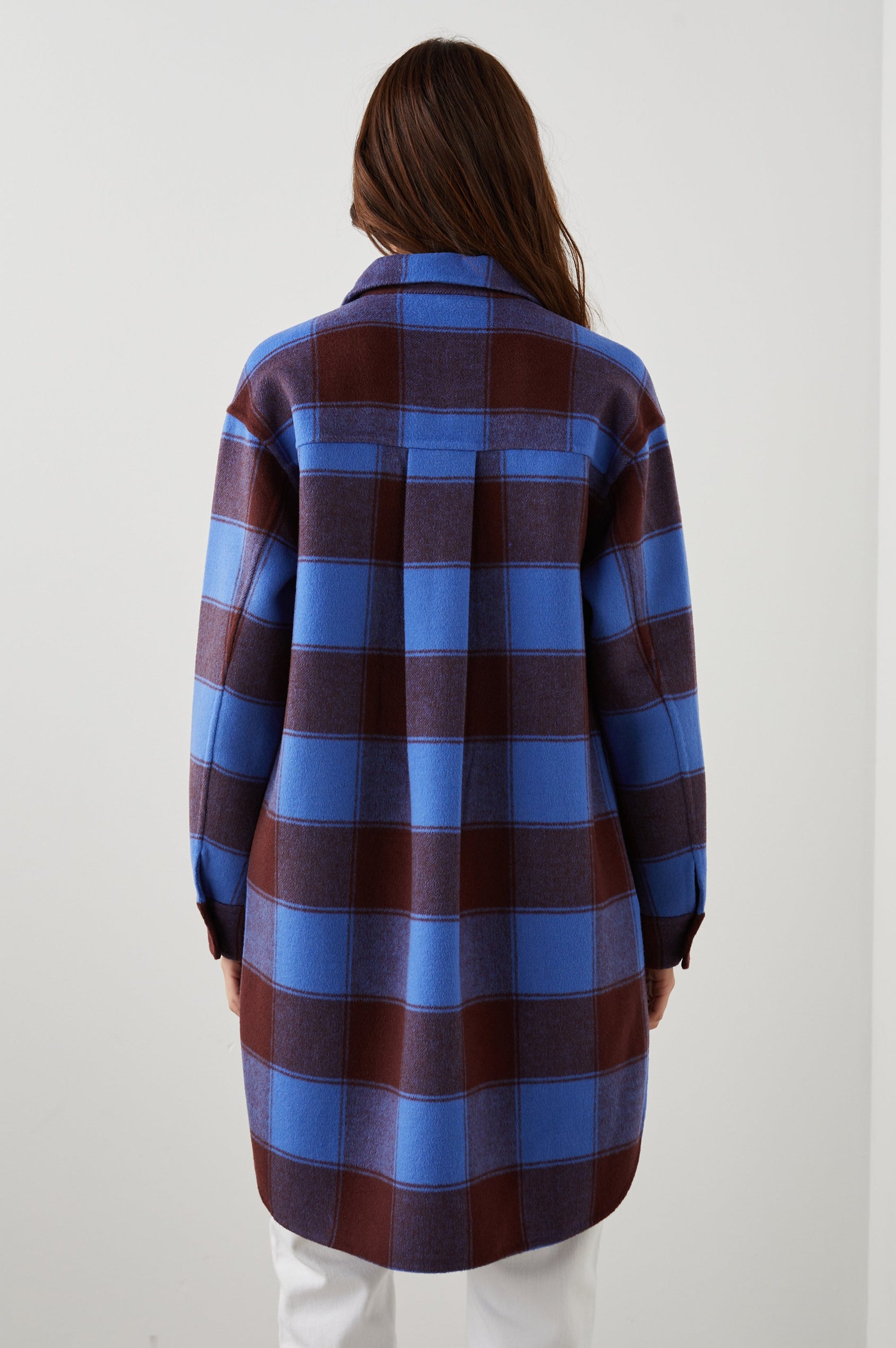 Jaro Mid-Thigh Length Coat with Button Closure, Button Cuffs, Two Chest Flap Pockets, Two Front Pockets and Side Hem Slits in Cobalt Chocolate Colorway, a Plaid - Back View Featured on Model 