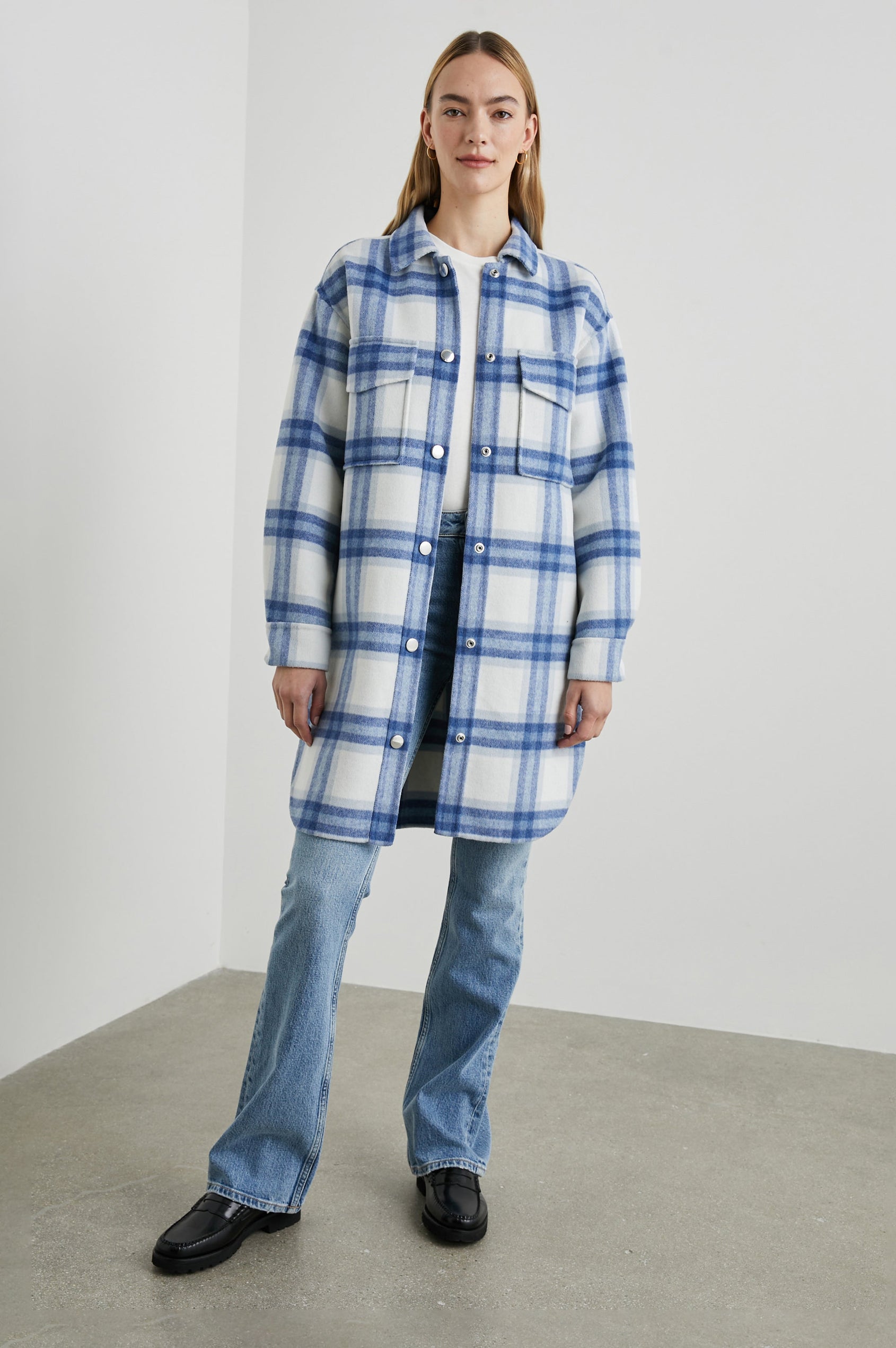 Jaro Mid-Thigh Length Coat with Snap Closure, Snap Cuffs, Two Chest Flap Pockets, Two Front Pockets and Side Hem Slits in Ivory Bay Colorway, an Ivory and Blue Plaid - Front Full Body View Featured on Model 