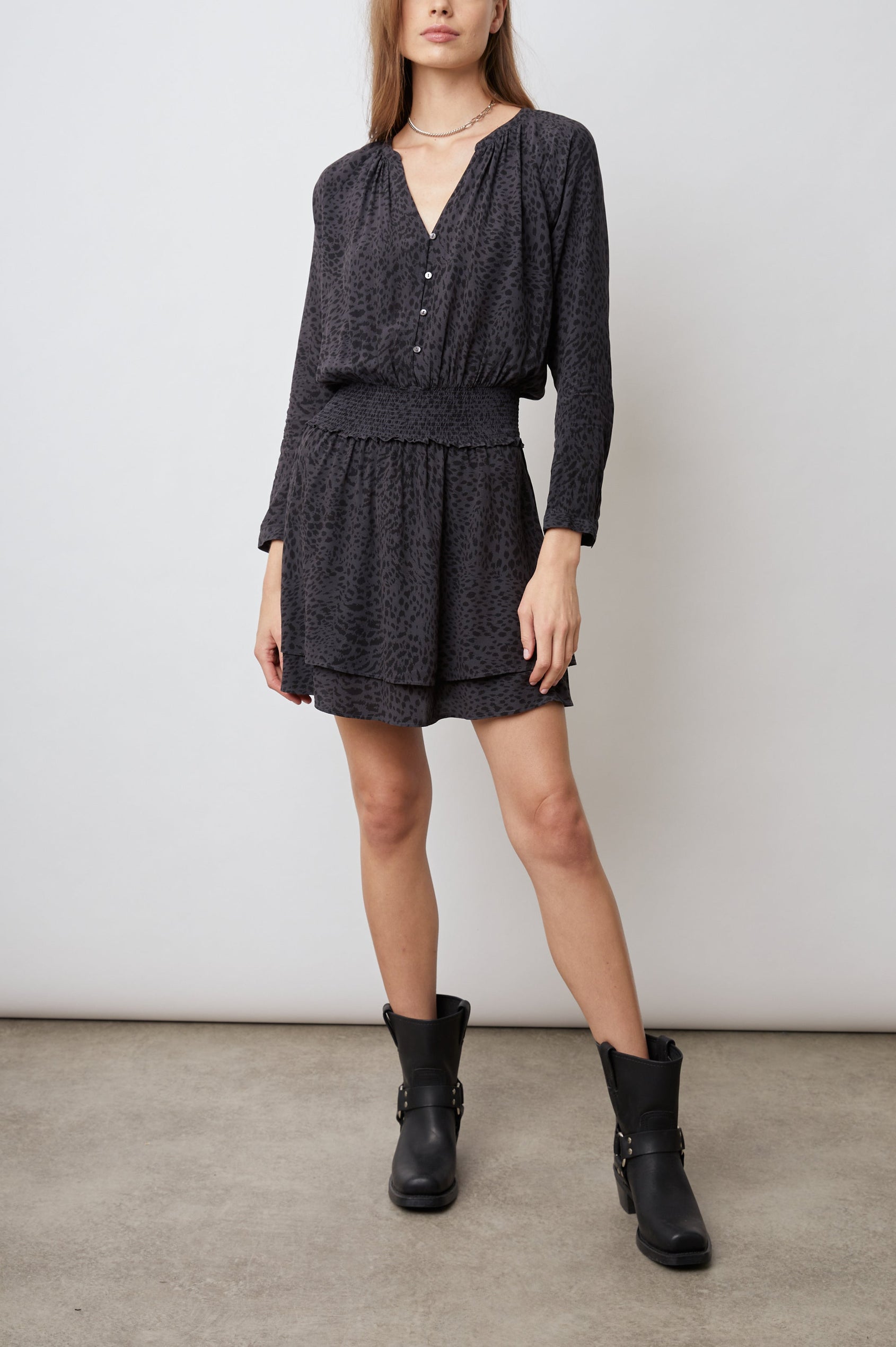 Jasmine Long-Sleeve Mini Dress with Buttons Down the Front Bodice, a Shirred Waist, a V Neck, Light Ruching Along the Neckline and a Double Layered Skirt in Spotted Slate Colorway, Black Spots on Slate - Front Full Body View Featured on Model 