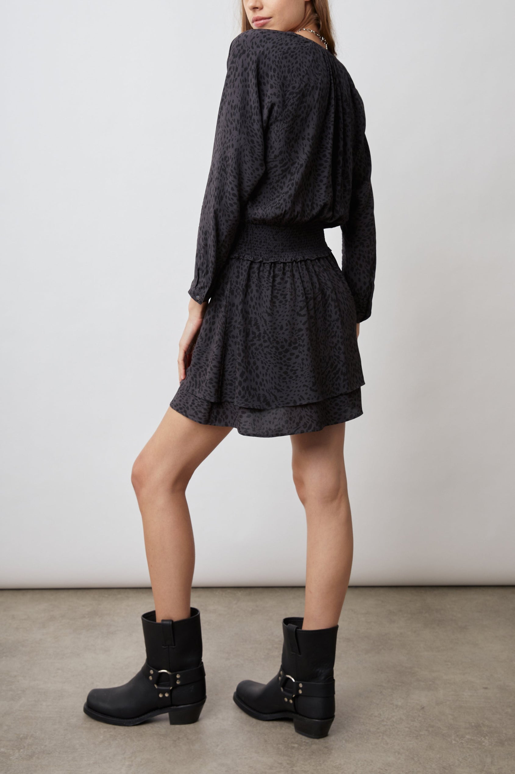 Jasmine Long-Sleeve Mini Dress with Buttons Down the Front Bodice, a Shirred Waist, a V Neck, Light Ruching Along the Neckline and a Double Layered Skirt in Spotted Slate Colorway, Black Spots on Slate - Side Full Body View Featured on Model 