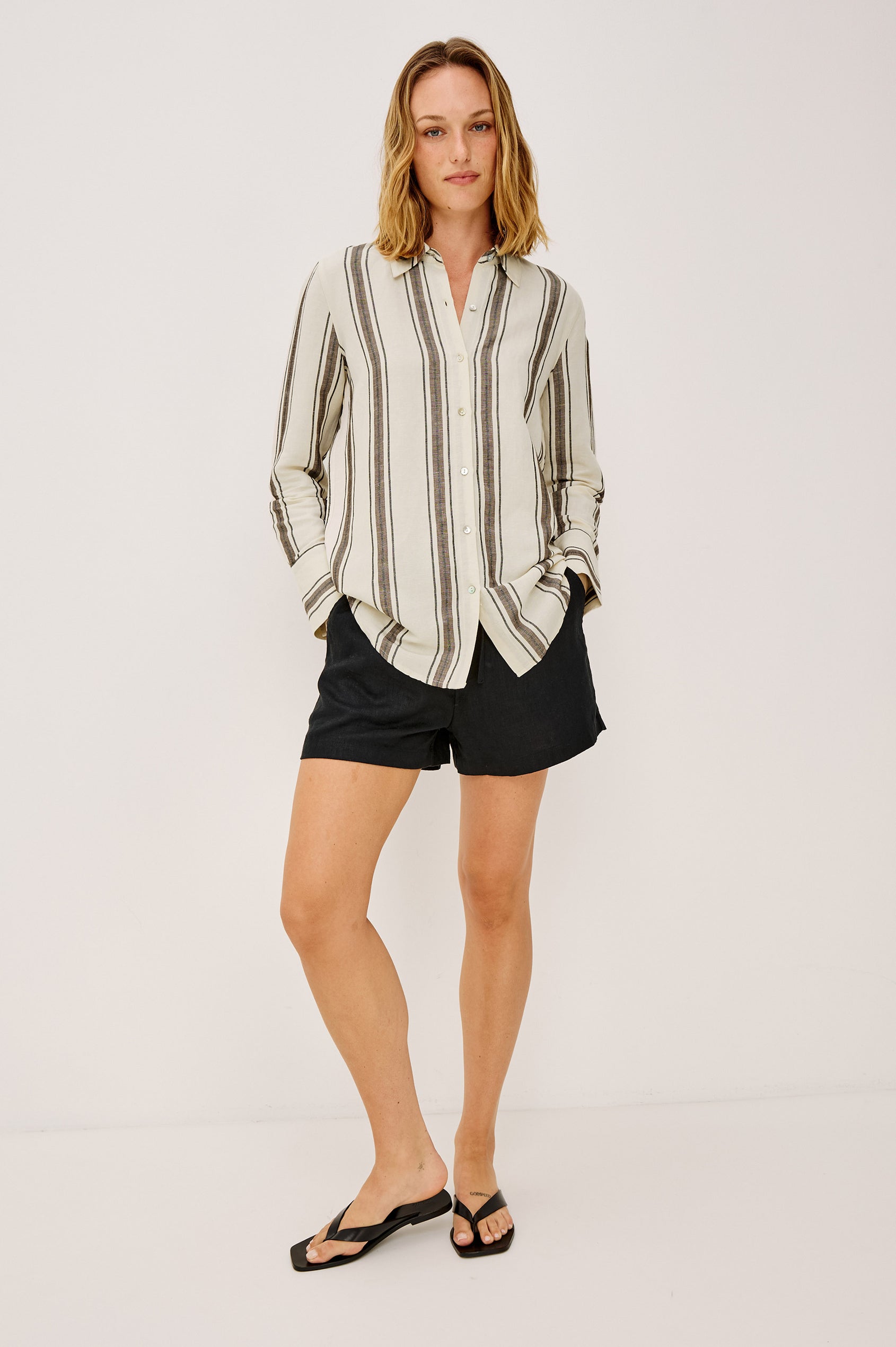 Jenner Short in Linen With High-Rise, Adjustable Drawstring Ties, Relaxed Fit, and Side Pockets in Black Colorway - Full Body Front View Featured on Model