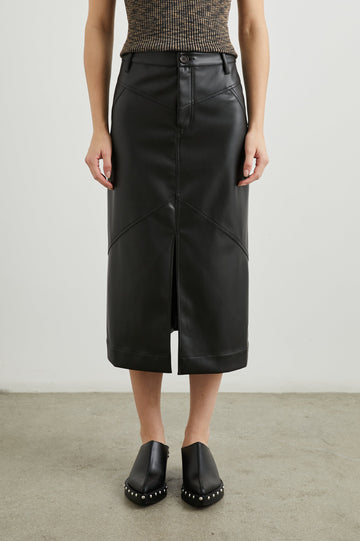 Jennifer Faux Leather Midi Skirt with a Center Slit, Belt Loops and Two Back Patch Pockets in Black Colorway - Front View Featured on Model 
