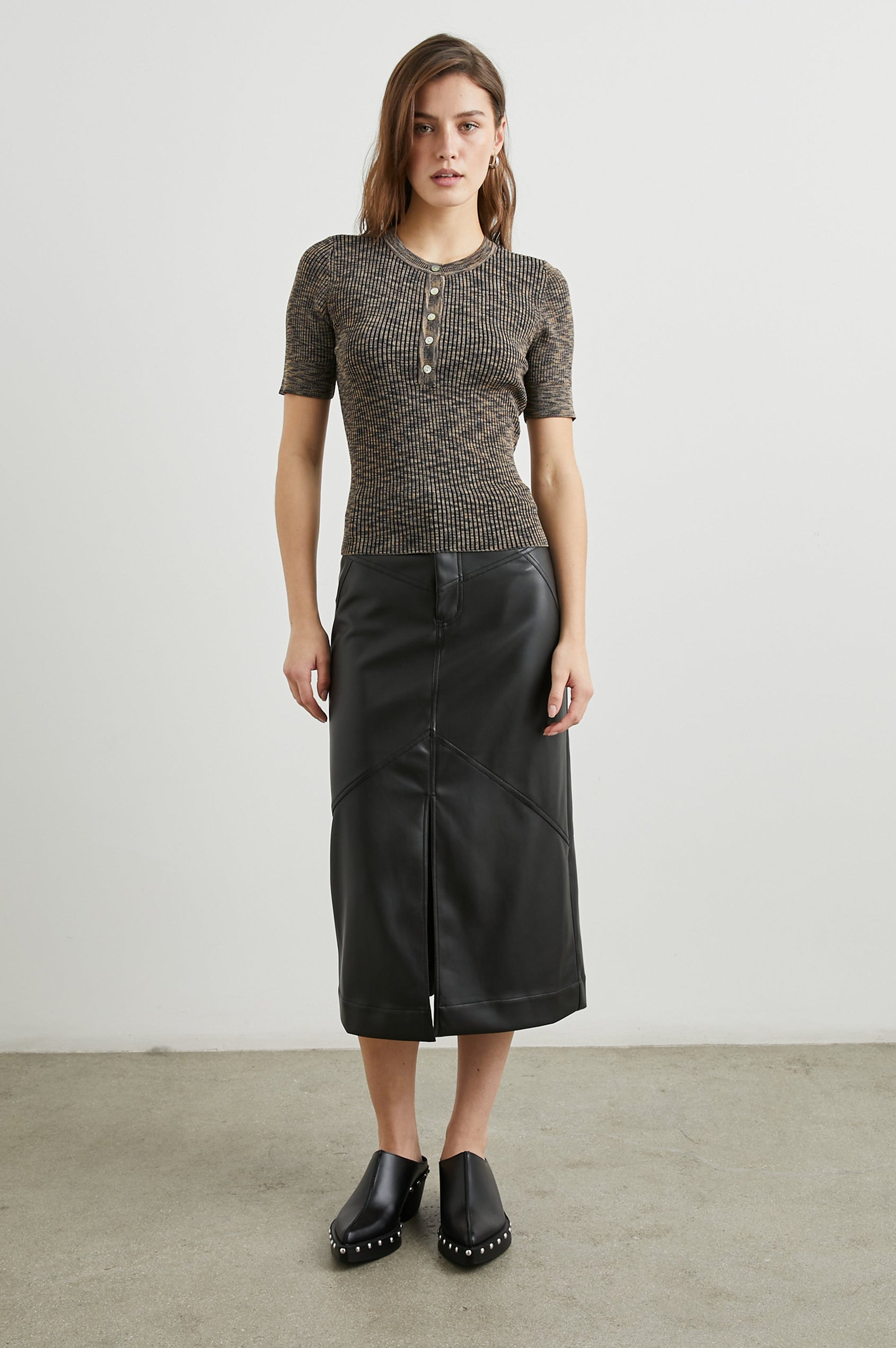 Jennifer Faux Leather Midi Skirt with a Center Slit, Belt Loops and Two Back Patch Pockets in Black Colorway - Front Full Body View Featured on Model 