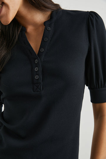 Jewel Top with Elbow-Length Sleeves, a Six Button Placket Creating a V Neck, Elasticized Cuffs and Light Ruching on Sleeves in Black Colorway - Front View Featured on Model