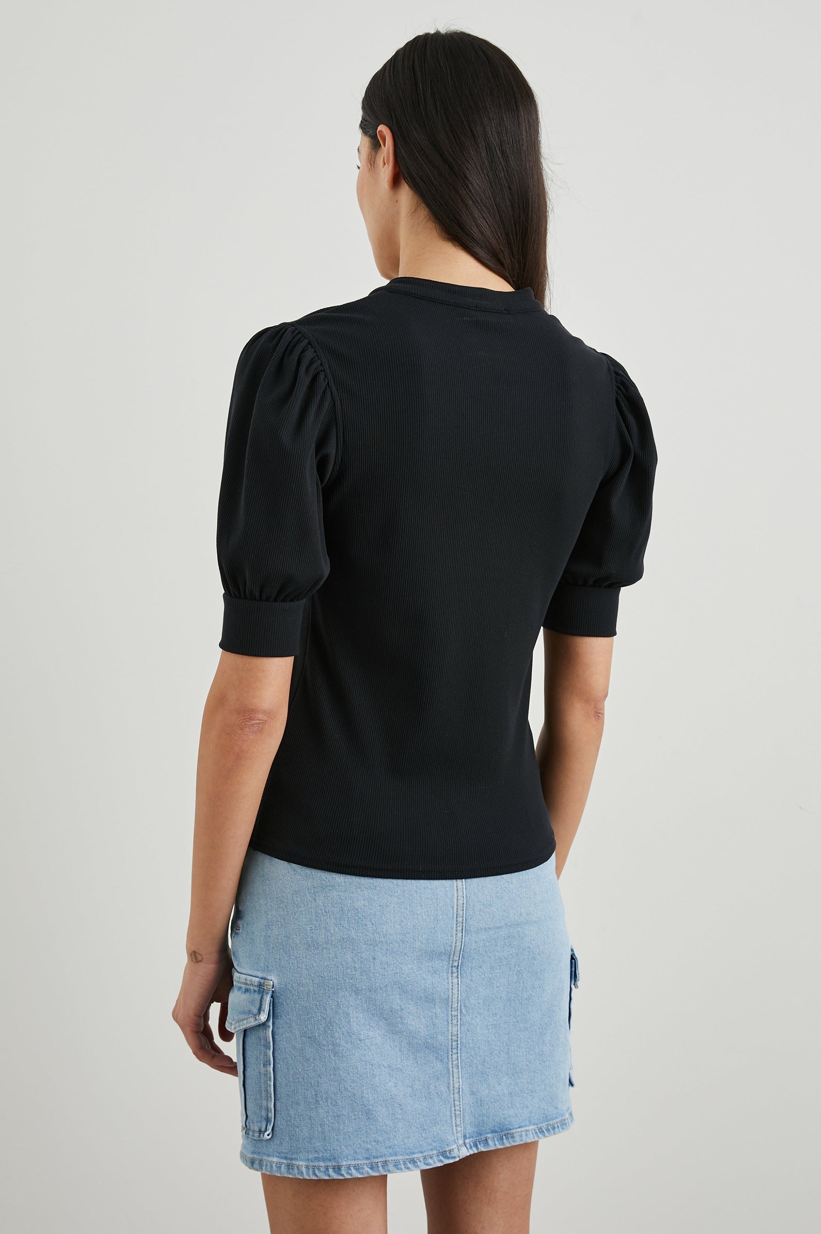 Jewel Top with Elbow-Length Sleeves, a Six Button Placket Creating a V Neck, Elasticized Cuffs and Light Ruching on Sleeves in Black Colorway - Back View Featured on Model