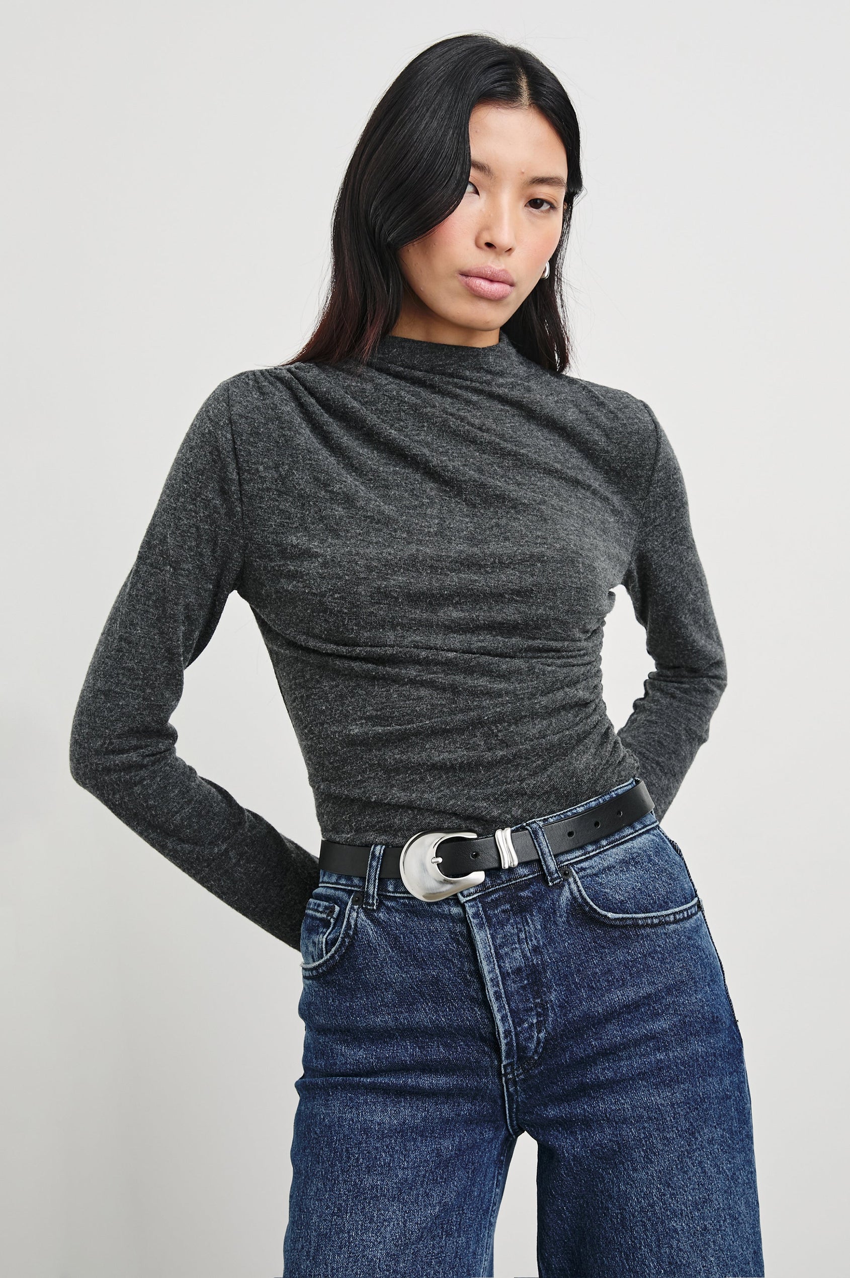 Joelle Long Sleeve Top with An Asymmetrical Mock Neck and Shirring on the Right Shoulder in Charcoal Colorway - Front Tucked View Featured on Model