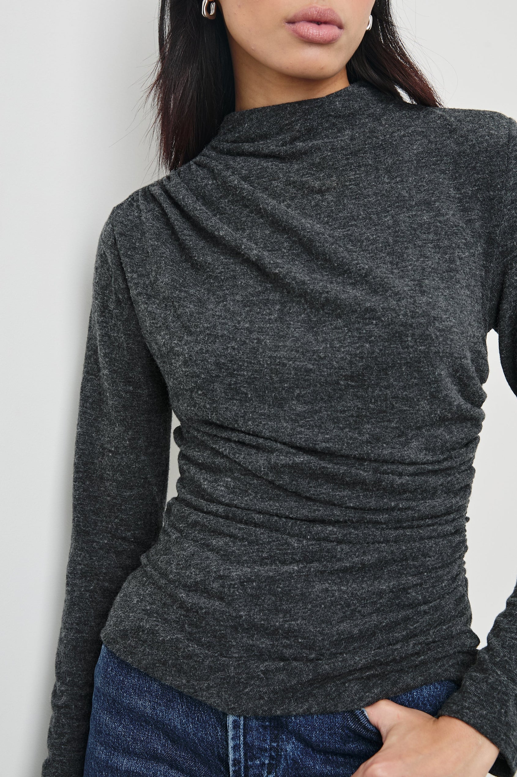 Joelle Long Sleeve Top with An Asymmetrical Mock Neck and Shirring on the Right Shoulder in Charcoal Colorway - Front View Featured on Model