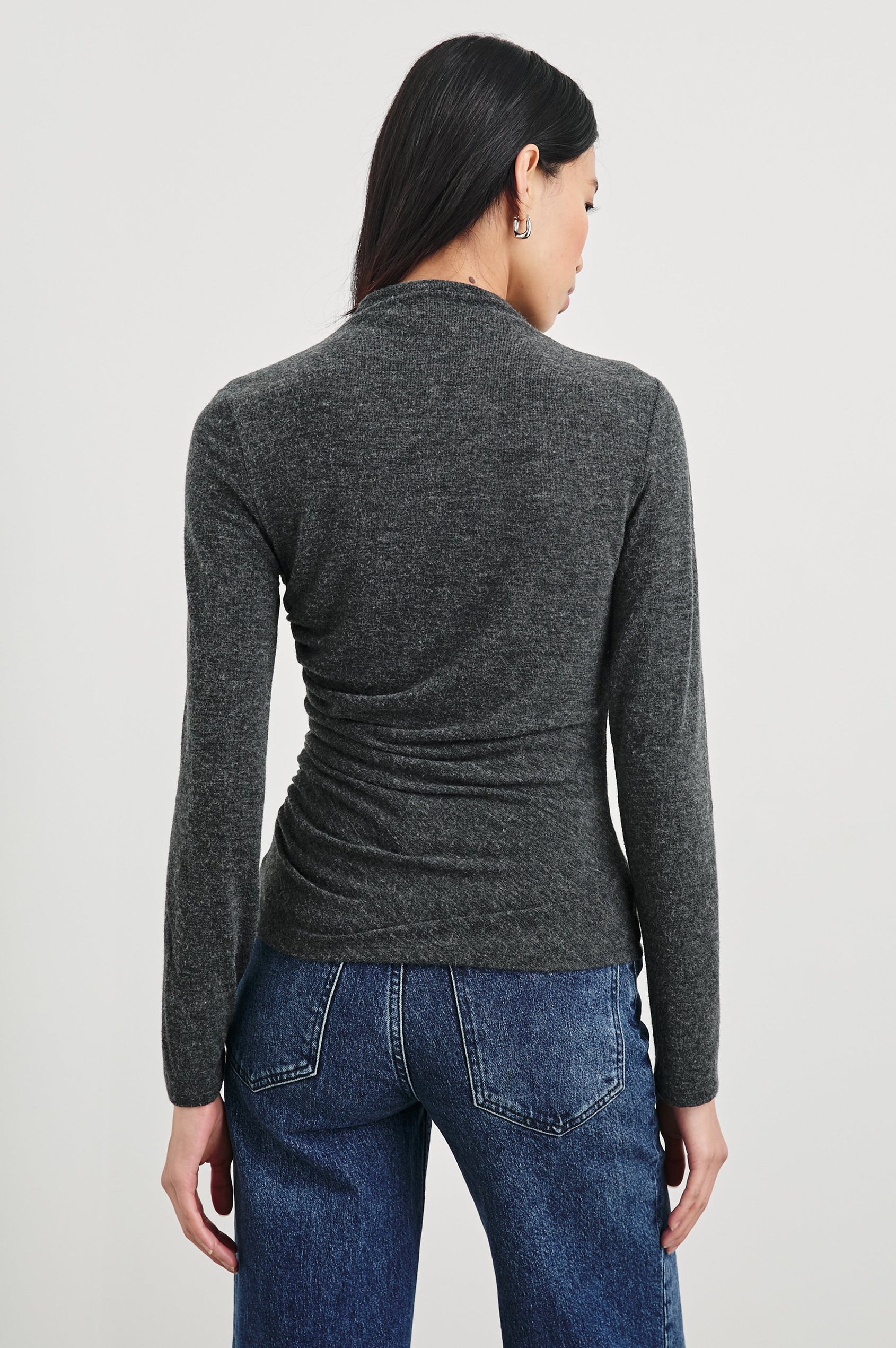 Joelle Long Sleeve Top with An Asymmetrical Mock Neck and Shirring on the Right Shoulder in Charcoal Colorway - Back View Featured on Model