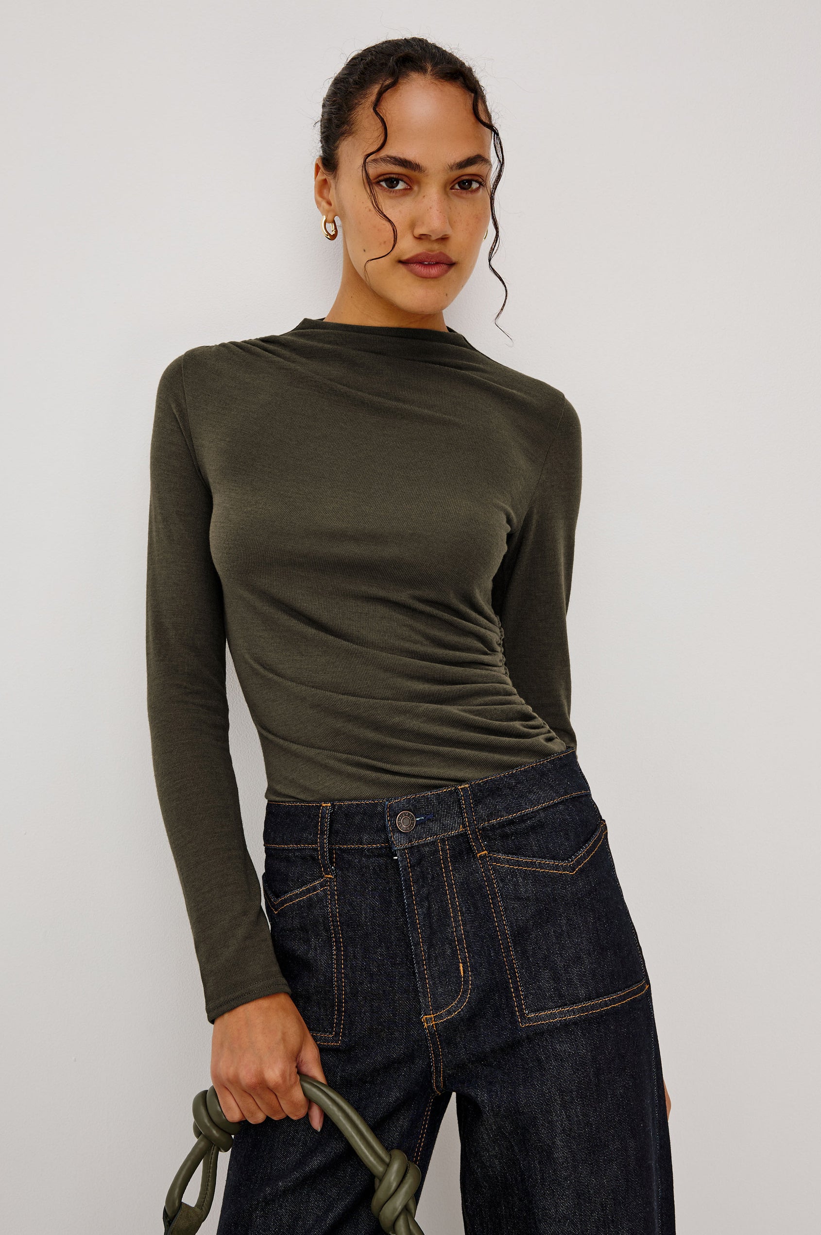 Joelle Top Fitted in Jersey With High Funnel Neckl, Long Sleeves, and Asymmetric Shoulder Shirring in Heather Olive Colorway - Upper Body Front View Featured on Model