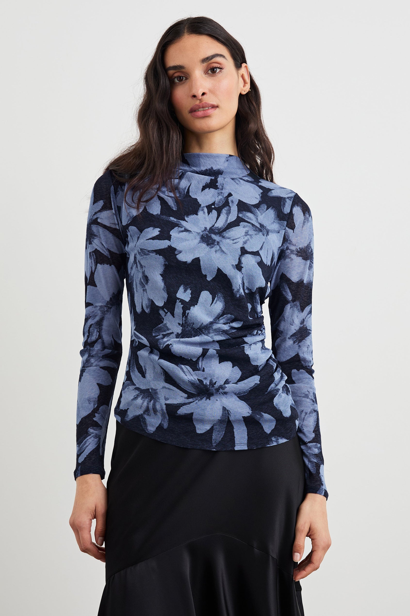 Joelle Long Sleeve Top with An Asymmetrical Mock Neck and Shirring on the Right Shoulder in Midnight Lily Colorway, with blue Lilies on Midnight - Front View Featured on Model