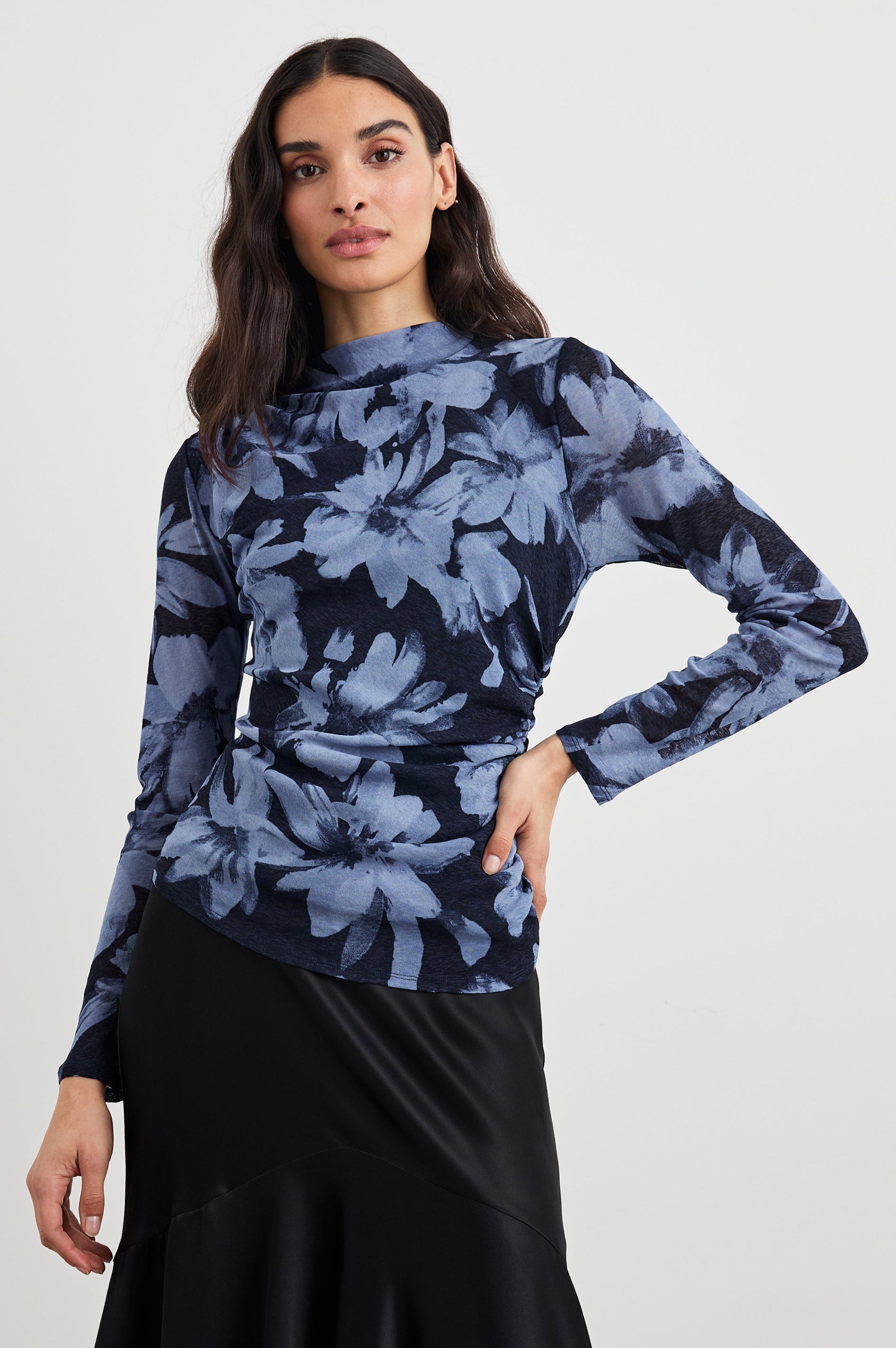 Joelle Long Sleeve Top with An Asymmetrical Mock Neck and Shirring on the Right Shoulder in Midnight Lily Colorway, with blue Lilies on Midnight - Front View Featured on Model