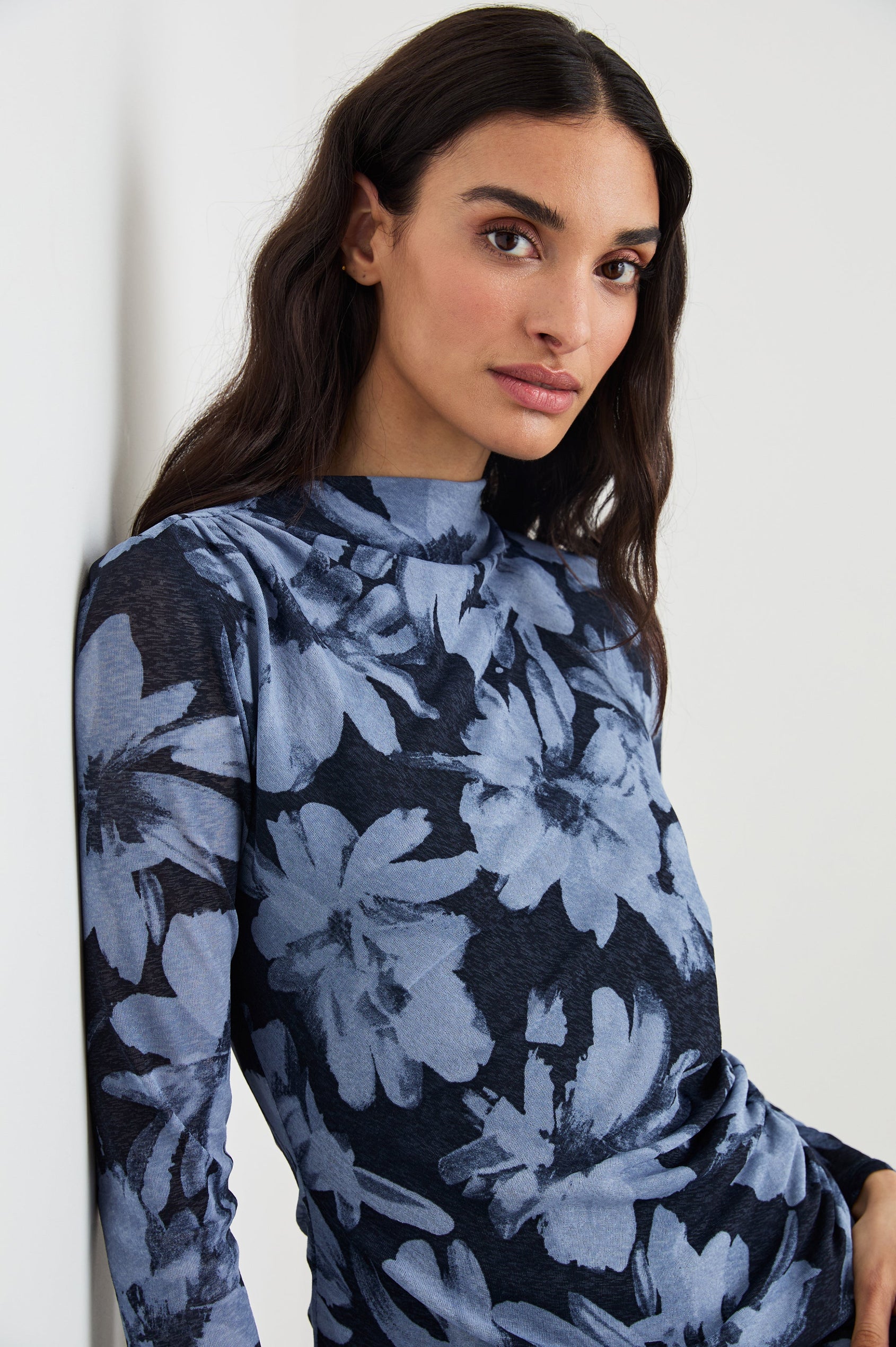 Joelle Long Sleeve Top with An Asymmetrical Mock Neck and Shirring on the Right Shoulder in Midnight Lily Colorway, with blue Lilies on Midnight - Front View Featured on Model