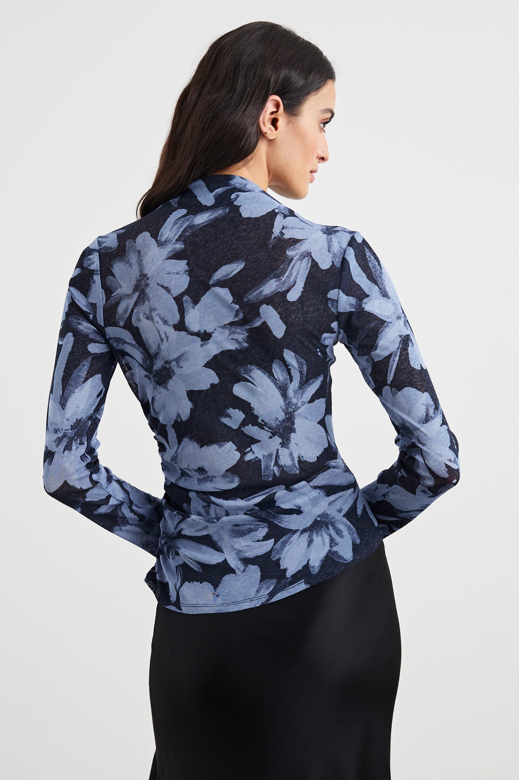 Joelle Long Sleeve Top with An Asymmetrical Mock Neck and Shirring on the Right Shoulder in Midnight Lily Colorway, with blue Lilies on Midnight - Back View Featured on Model