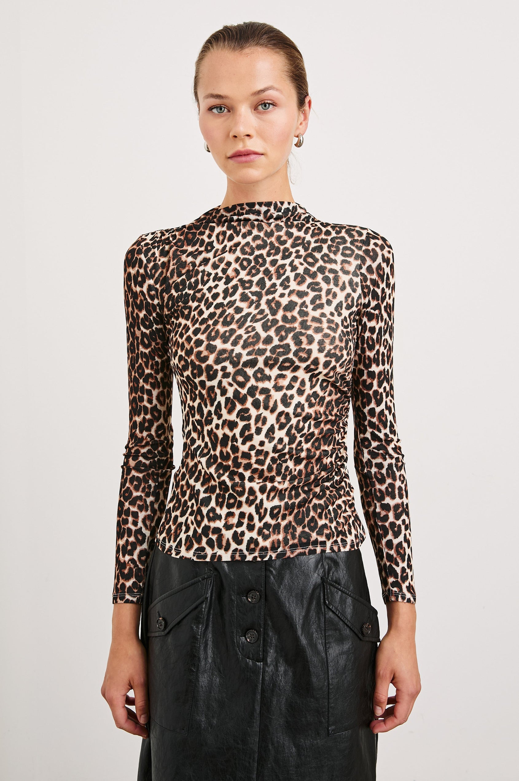 Joelle Long Sleeve Top with An Asymmetrical Mock Neck and Shirring on the Right Shoulder in Nala Colorway, with brown and black leopard spots on White - Front View Featured on Model