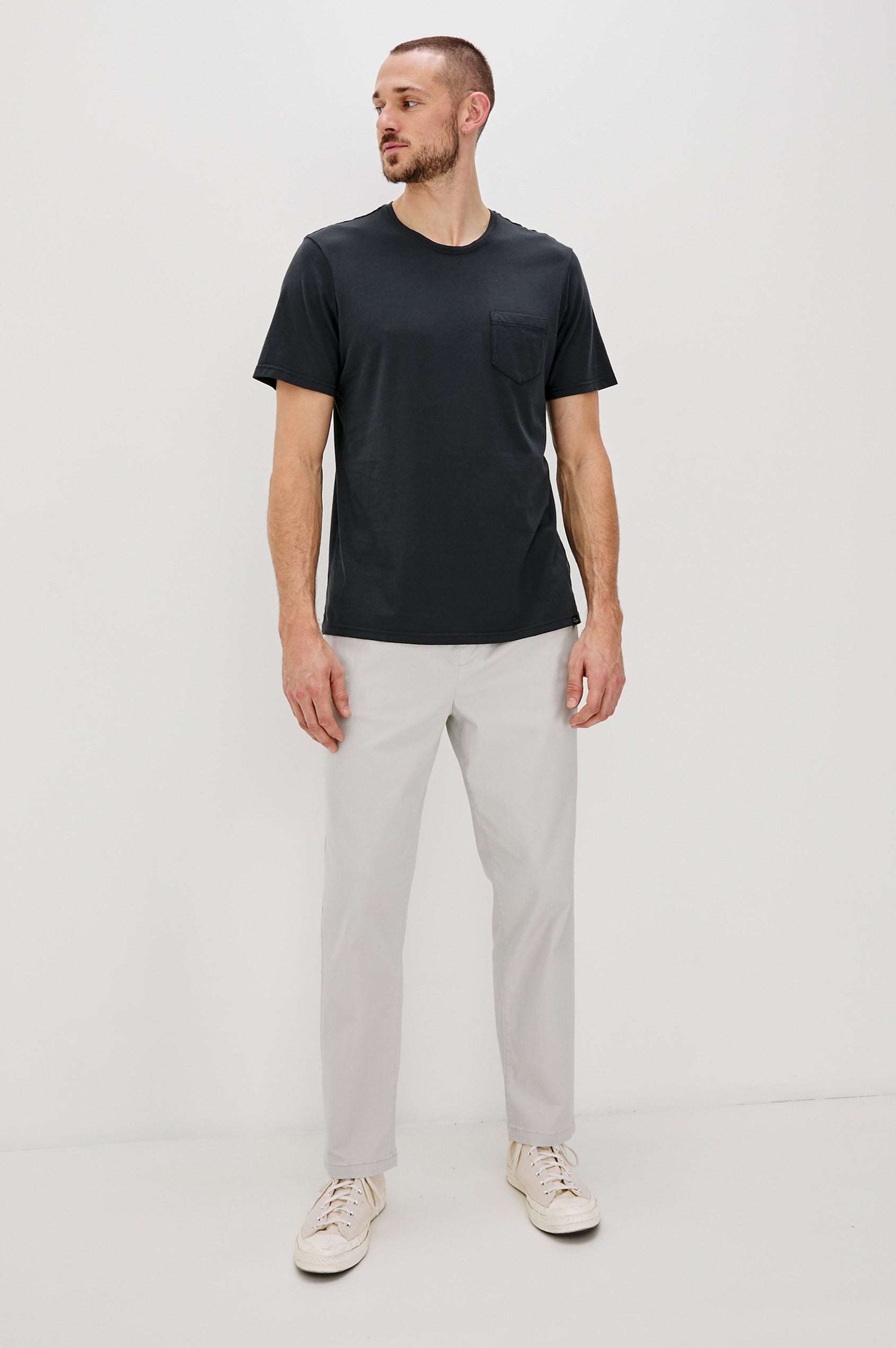Johnny Short Sleeve T-Shirt with a Crew Neck, Chest Patch Pocket and Small Slits at the Side Hems in Carbon Colorway - Front Full Body View Featured on Model