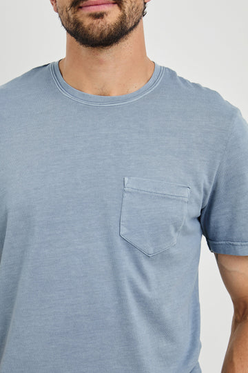 Johnny Short Sleeve T-Shirt with a Crew Neck, Chest Patch Pocket and Small Slits at the Side Hems in Steel Colorway - Front View Featured on Model