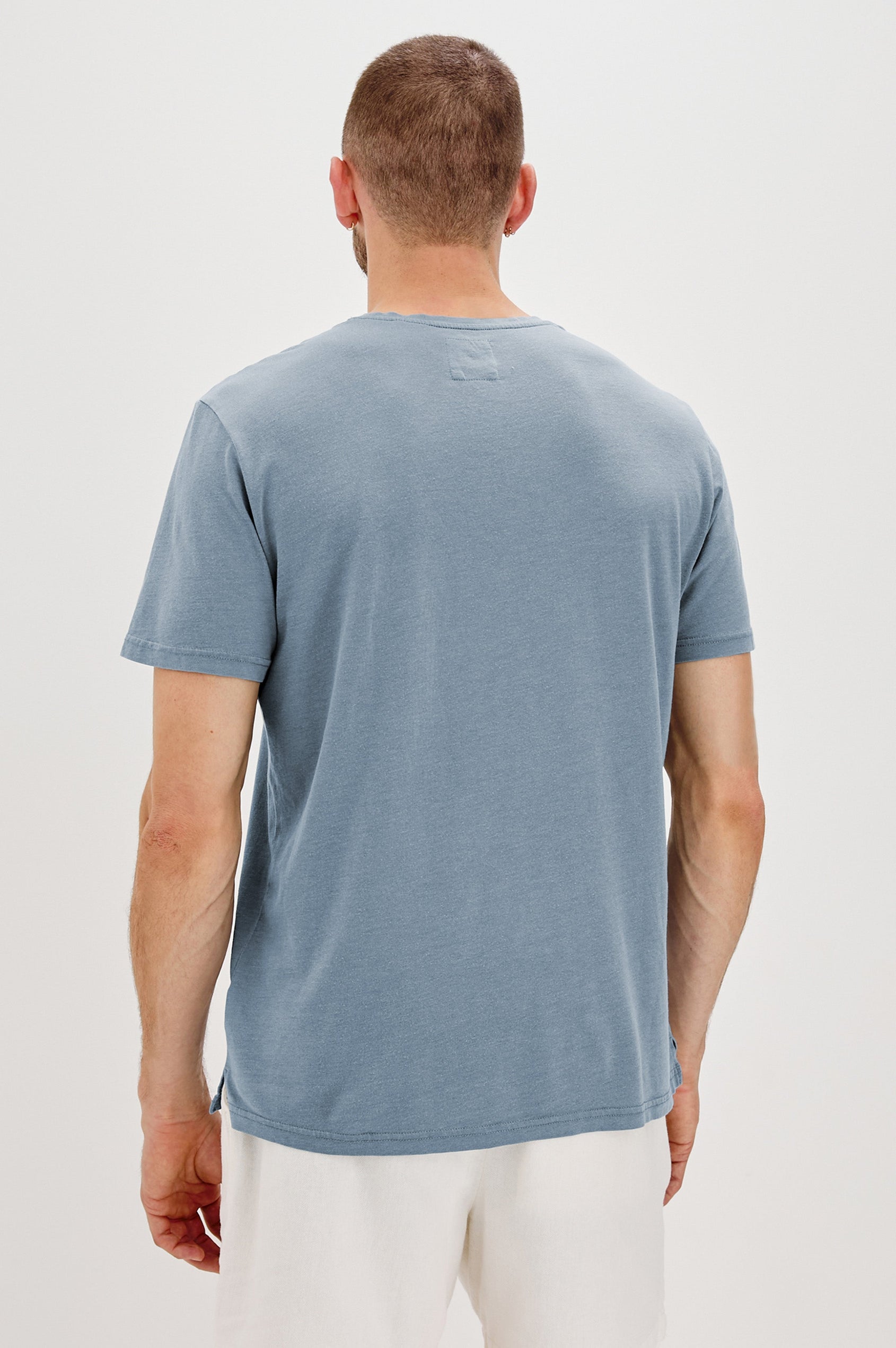 Johnny Short Sleeve T-Shirt with a Crew Neck, Chest Patch Pocket and Small Slits at the Side Hems in Steel Colorway - Back View Featured on Model