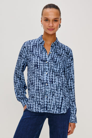 Josephine Collared Button Front Shirt with Long Sleeves and a Front Chest Pocket in Indigo Shibori Colorway. Front View featured on model.