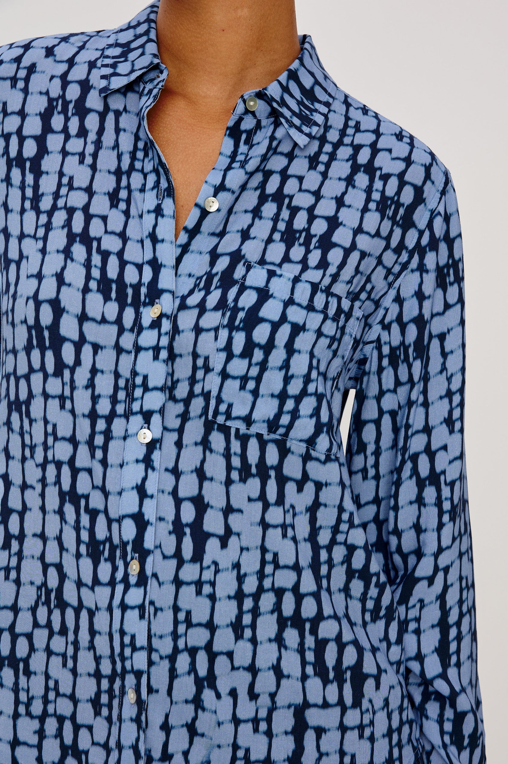 Josephine Collared Button Front Shirt with Long Sleeves and a Front Chest Pocket in Indigo Shibori Colorway. Close up of details featured on model.