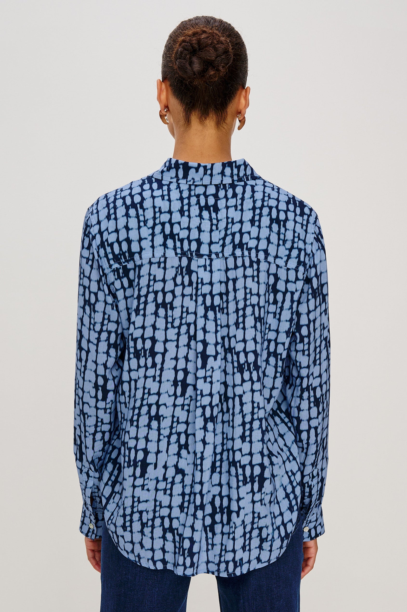 Josephine Collared Button Front Shirt with Long Sleeves and a Front Chest Pocket in Indigo Shibori Colorway. Back View featured on model. 