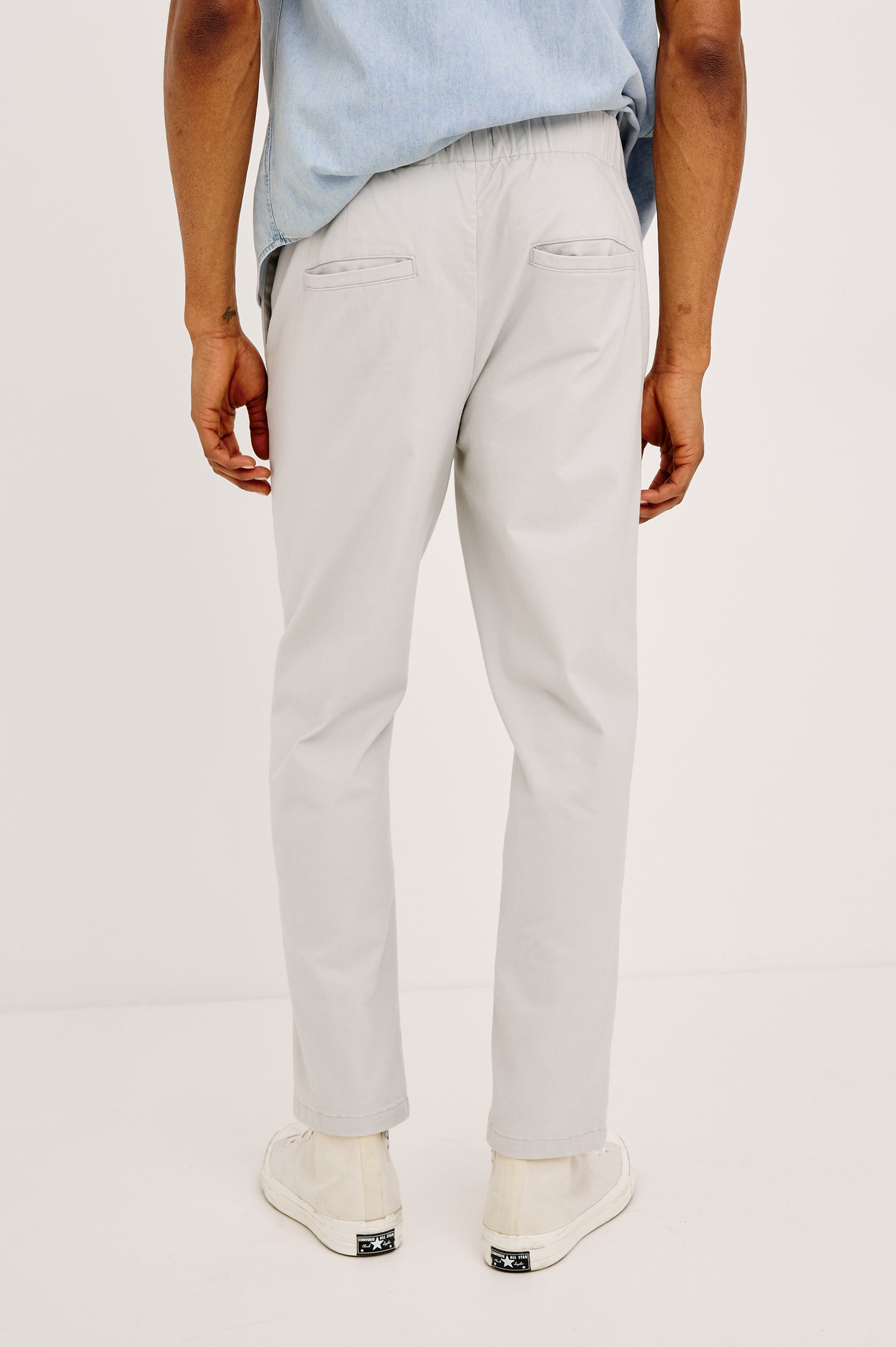 Julian Pants with an Elastic Waist, Two Front Pockets and Two Back Welt Pockets in Natural Colorway - Back View Featured on Model