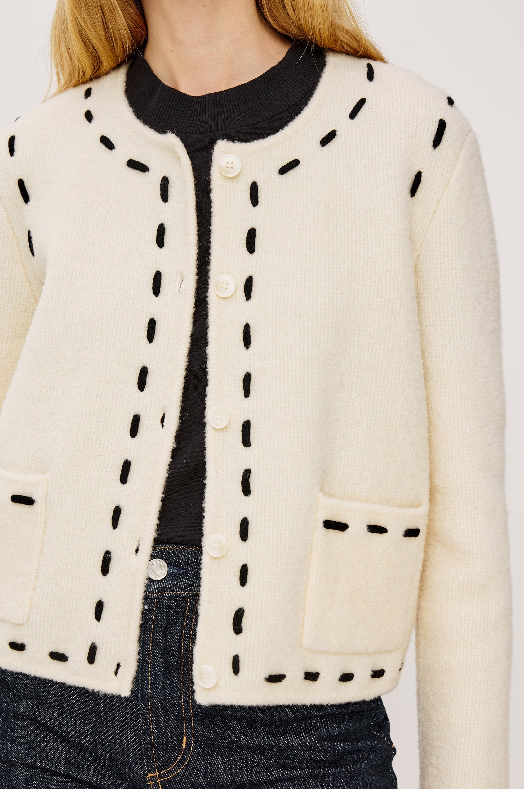 Juliette Long-Sleeve Cardigan with Button Closure, Two Front Patch Pockets, and Crew Neck in Ivory Colorway, with Black Trim Stitching - Close Up View Featured on Model