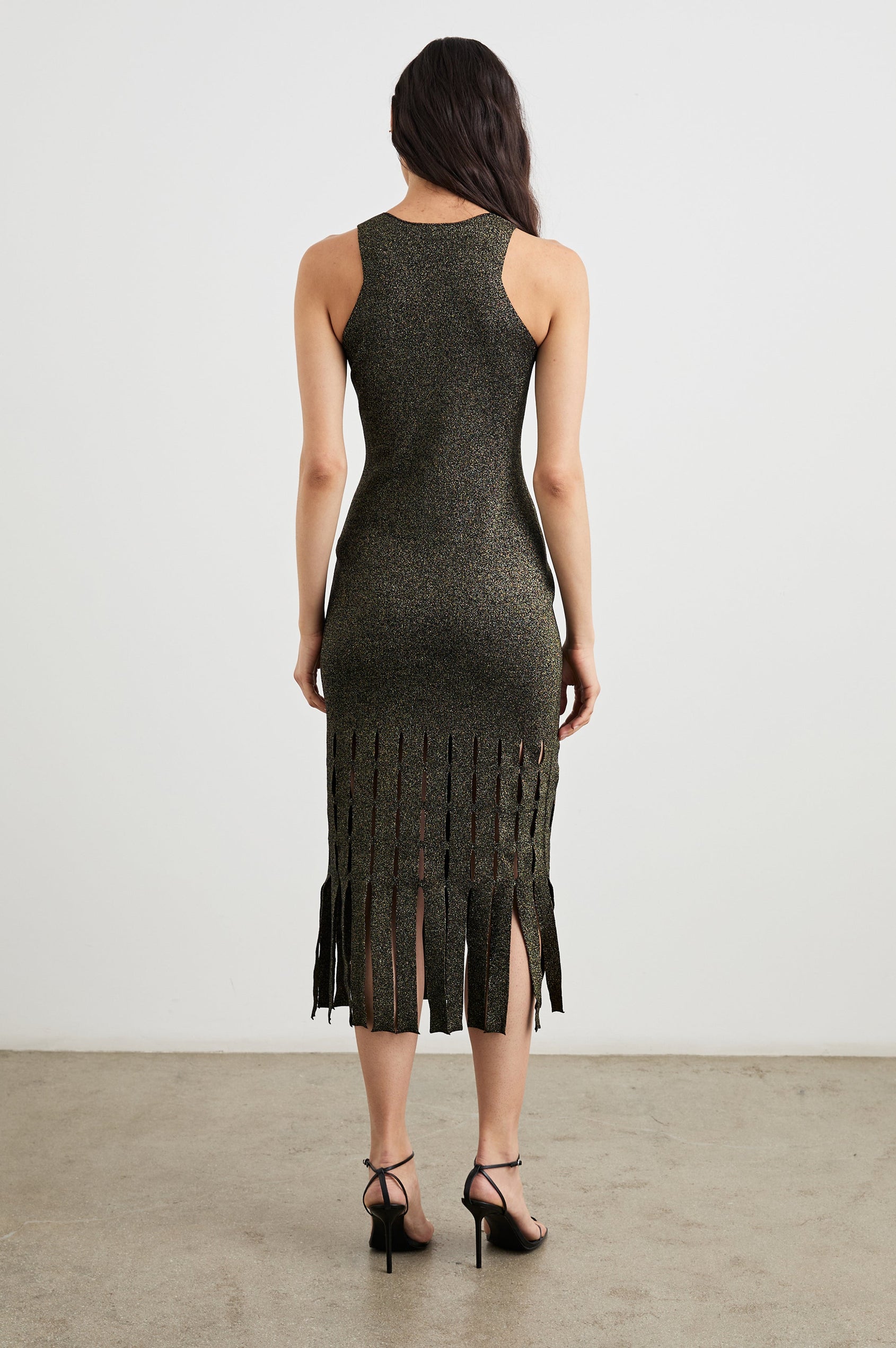 Kaia Sleeveless Midi Dress with a V Neck and Vertical Dashed Cutouts From the Thigh Downward, ending in Panels in Gold Lurex Colorway - Back Full Body View Featured on Model