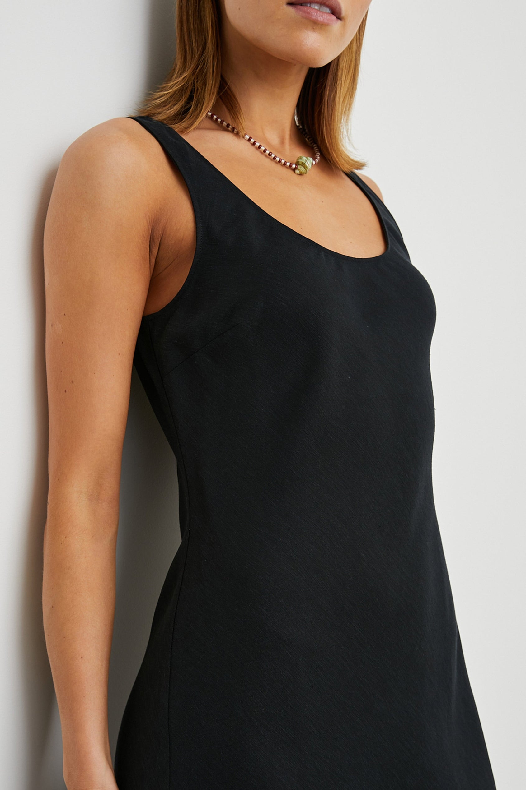 Kailani Sleeveless Midi Dress with Shoulder Straps, a Scoop Neck and Side Slit to the Knee in Black Colorway - Front View Featured on Model