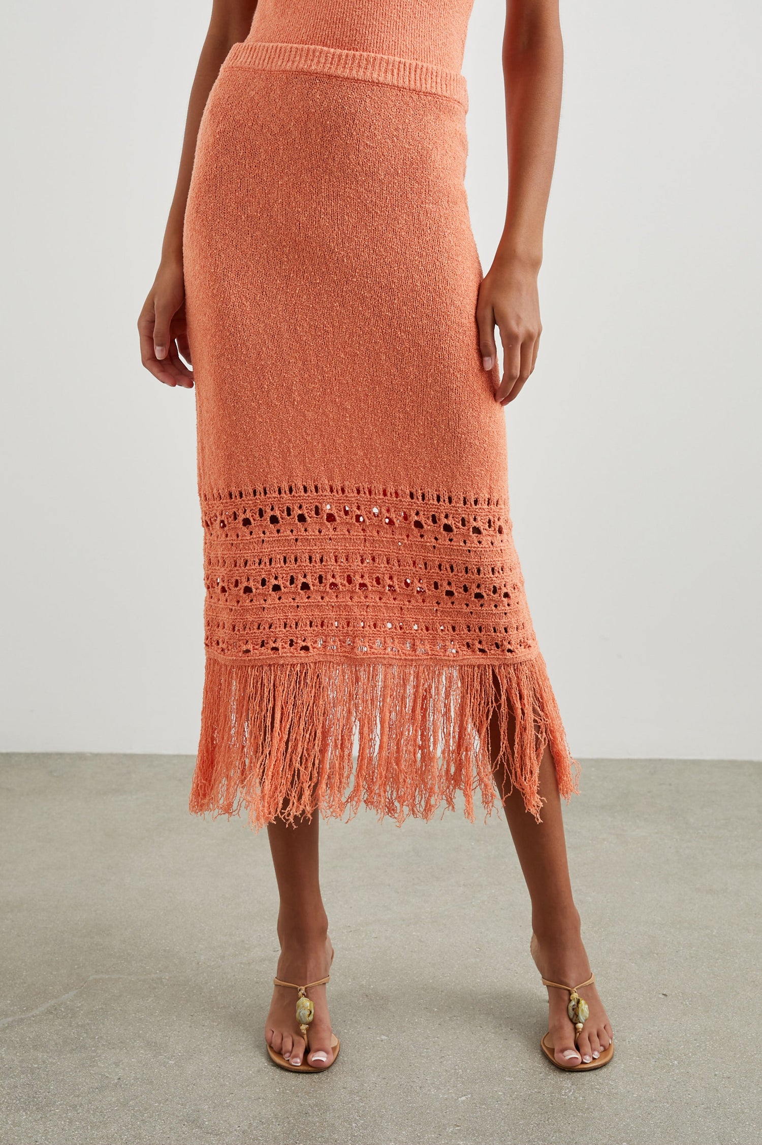 Kaja Midi Skirt with a Crochet Design Along the Bottom and Fringe at the Hem in Persimmon Colorway - Front View Featured on Model  