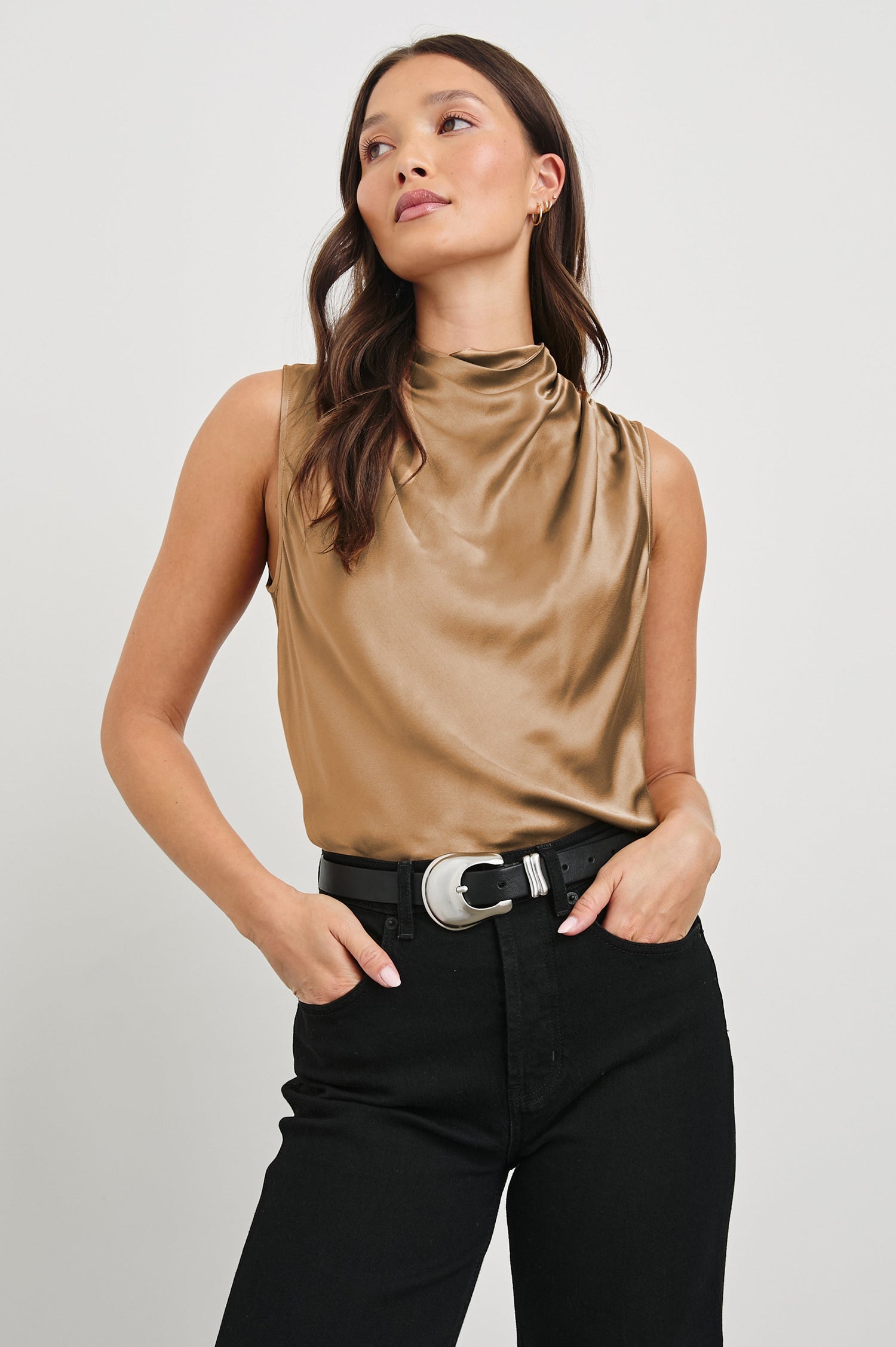 Kaleen Sleeveless Top with Mock Neck with Buttons and Keyhole on the Back and Draped Fabric on the Upper Chest in Camel Colorway - Front Tucked View Featured on Model