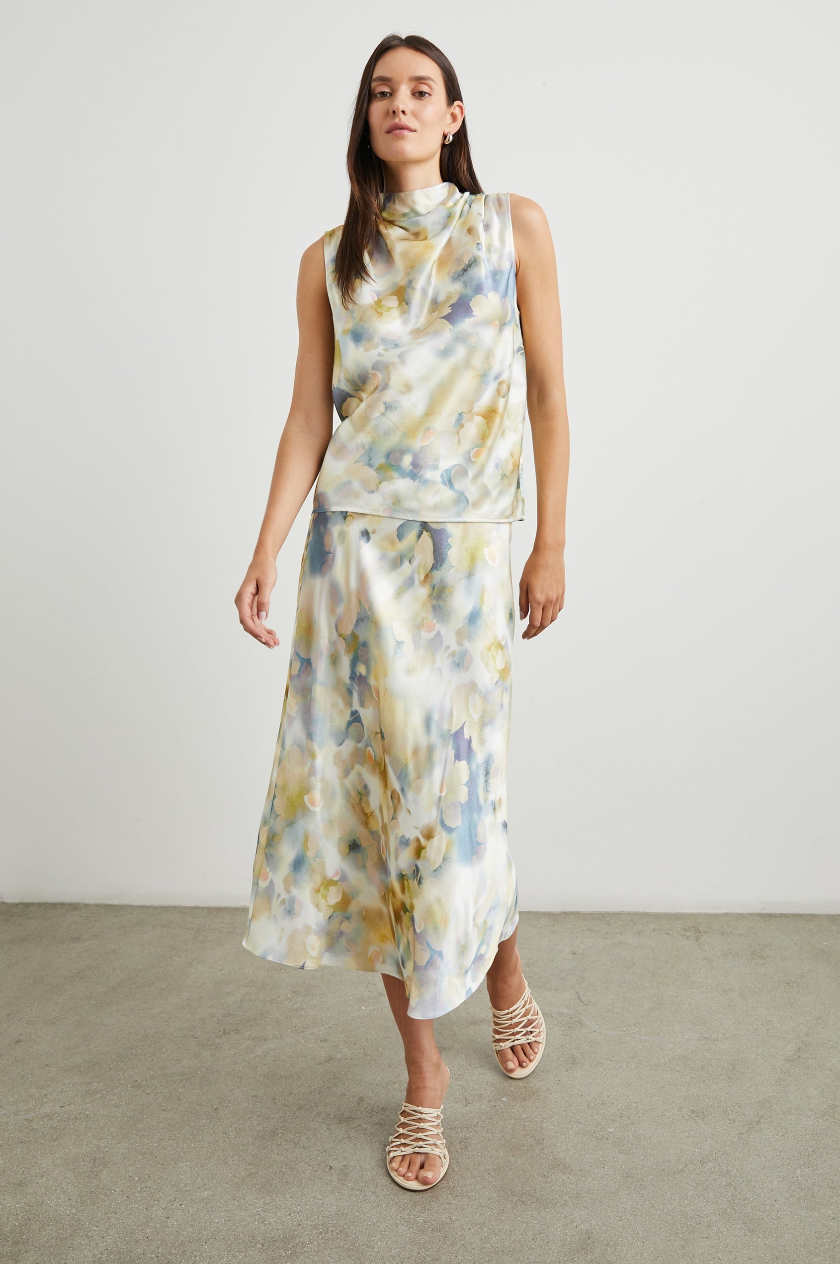 Kaleen Sleeveless Top with Mock Neck with Buttons and Keyhole on the Back and Draped Fabric on the Upper Chest in Diffused Blossom Colorway, in creams, yellows and blues - Front Full Body View Featured on Model