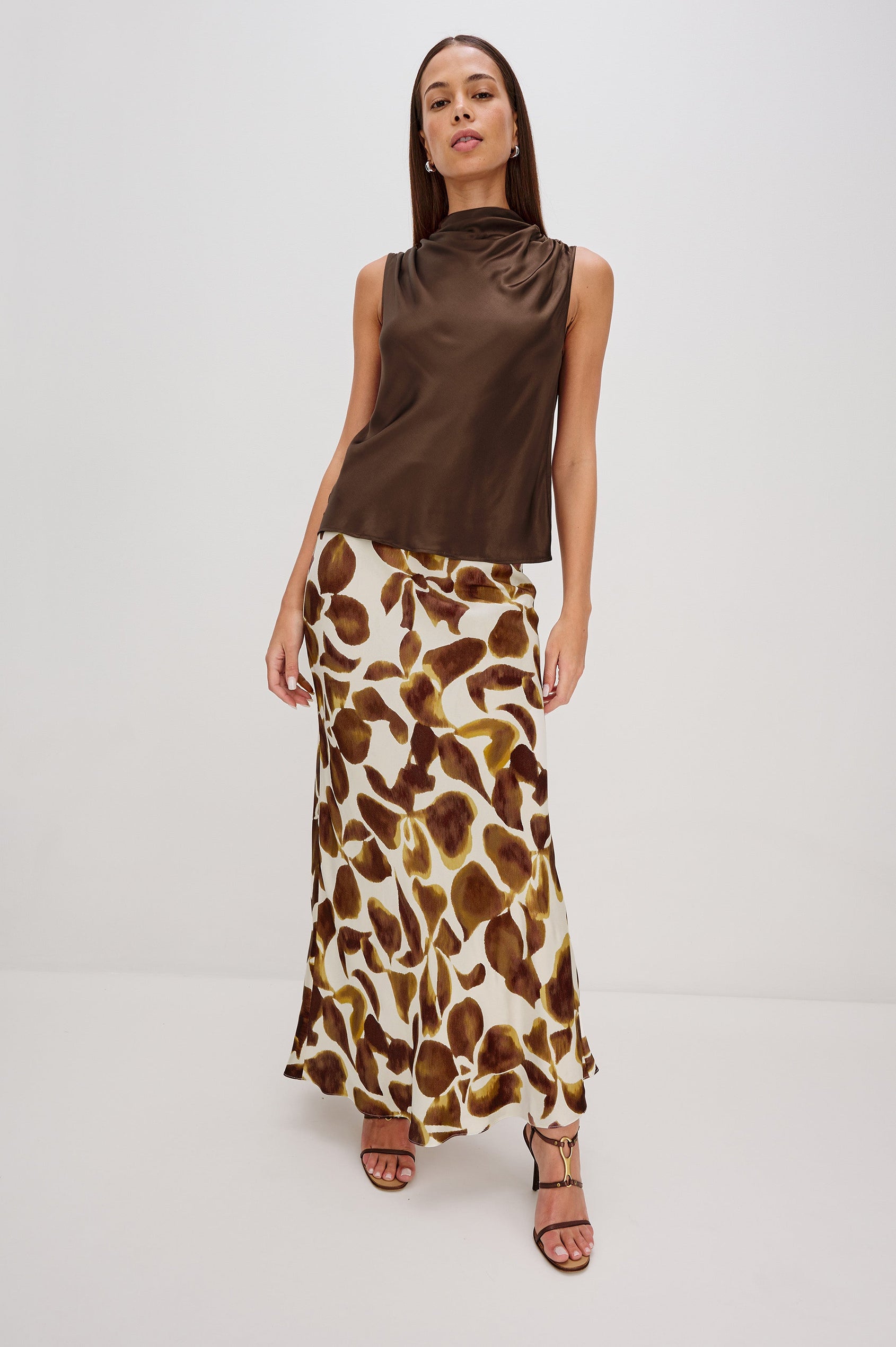 Kaleen Sleeveless Top with Mock Neck with Buttons and Keyhole on the Back and Draped Fabric on the Upper Chest in Espresso Colorway - Full Body Front View Featured on Model