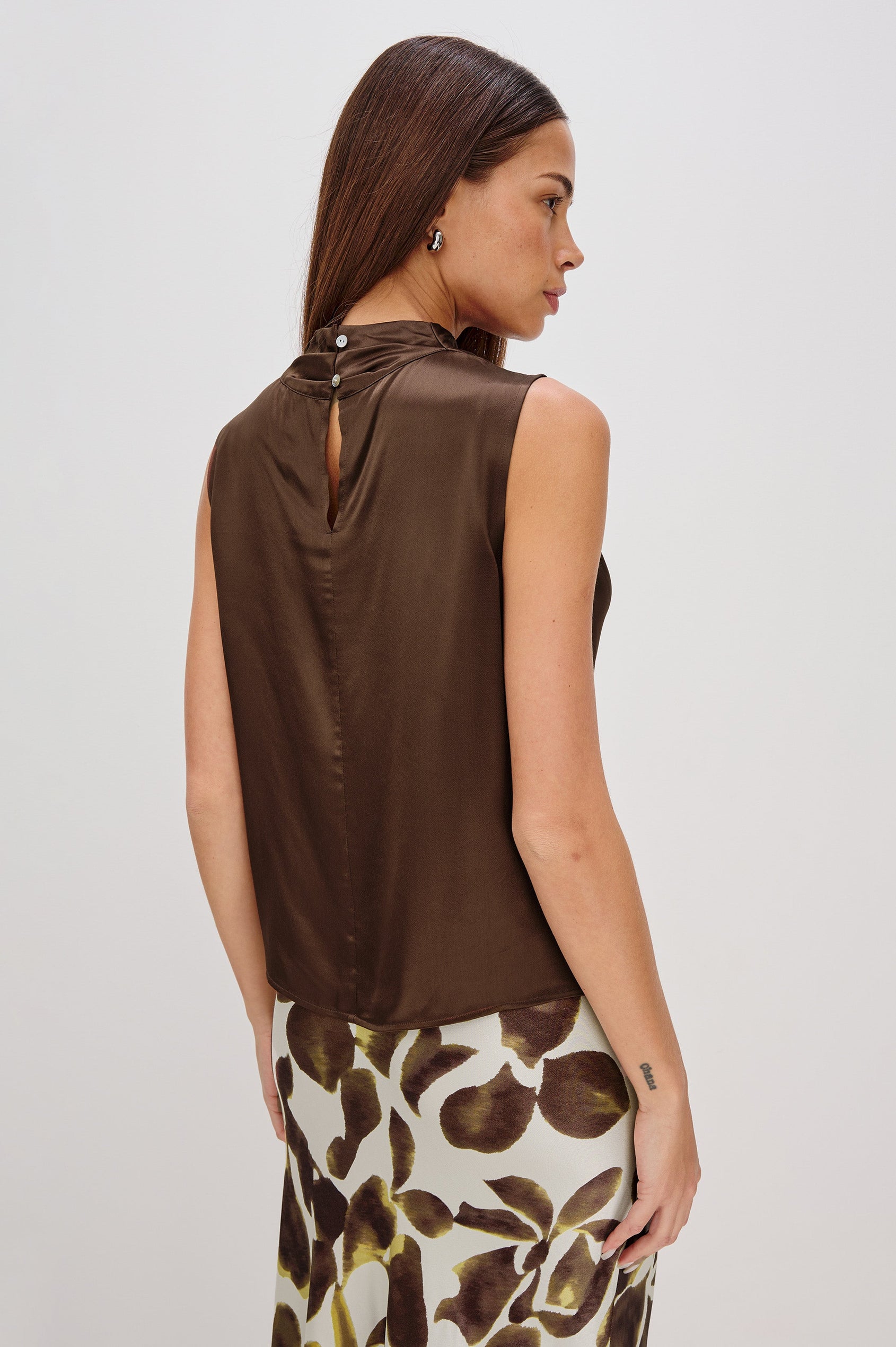 Kaleen Sleeveless Top with Mock Neck with Buttons and Keyhole on the Back and Draped Fabric on the Upper Chest in Espresso Colorway - Back View Featured on Model