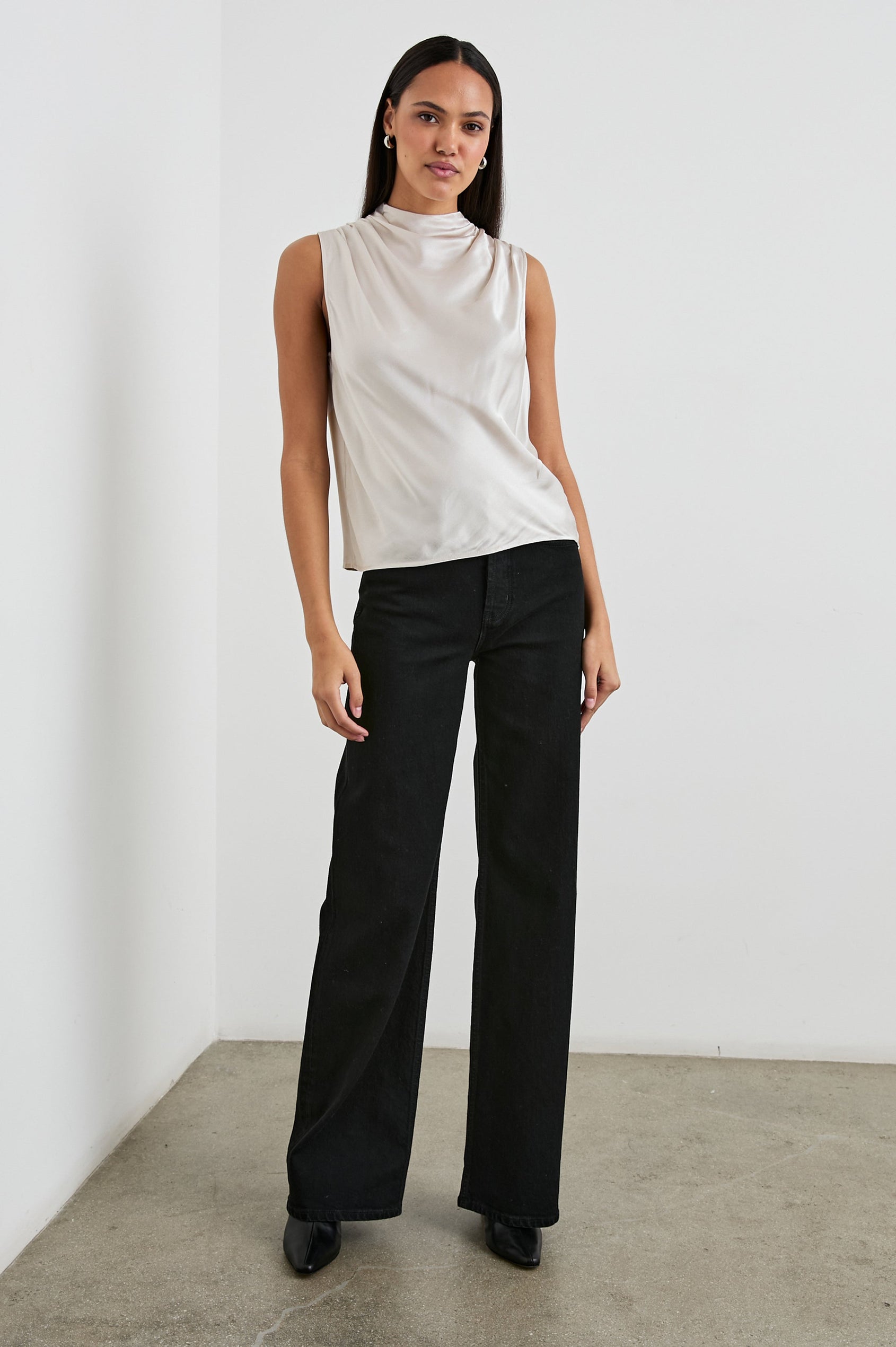 Kaleen Sleeveless Top with Mock Neck with Buttons and Keyhole on the Back and Draped Fabric on the Upper Chest in Ivory Colorway- Front Full Body View Featured on Model