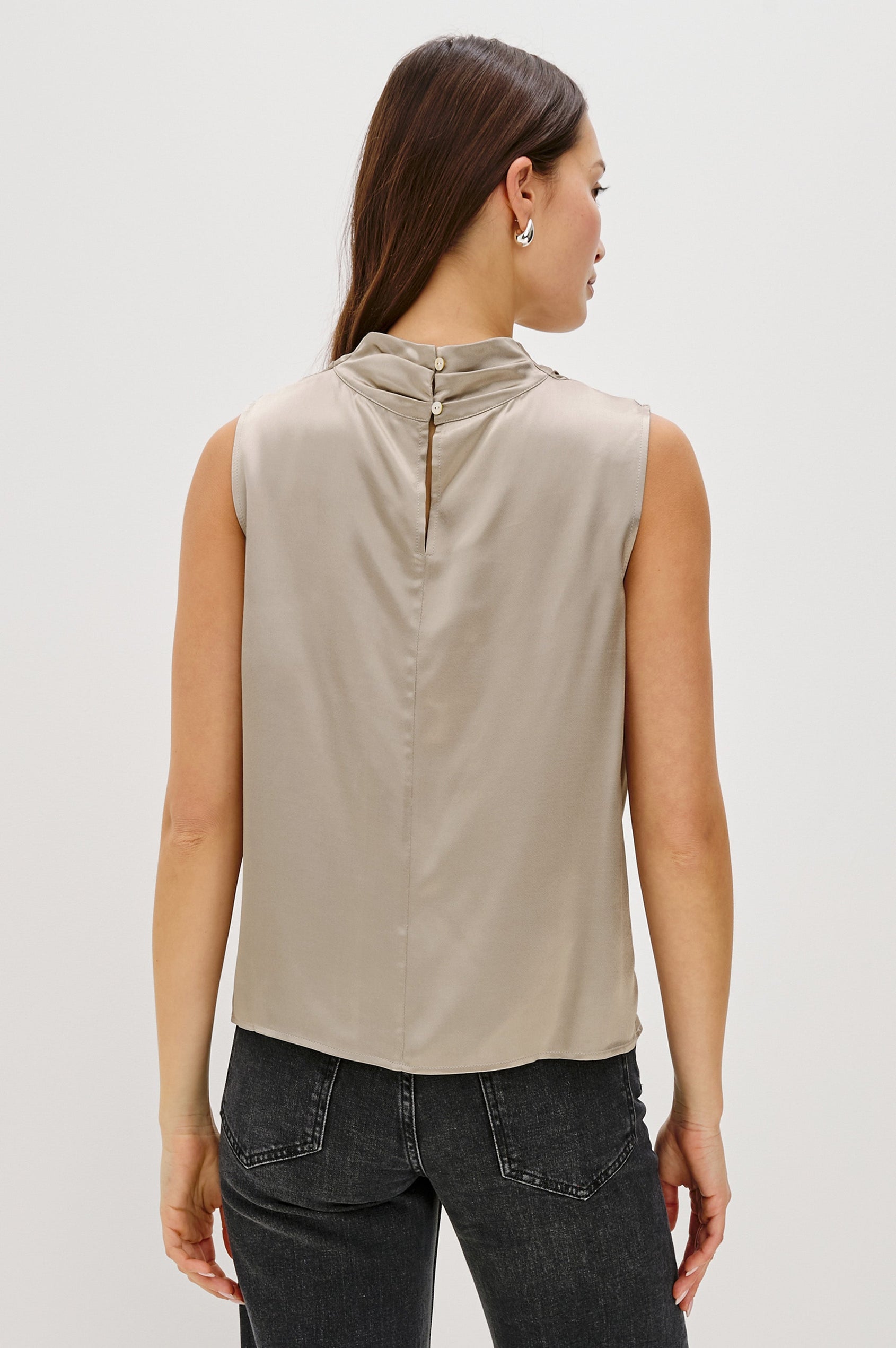 Kaleen Sleeveless Top with Mock Neck with Buttons and Keyhole on the Back and Draped Fabric on the Upper Chest in Mink Colorway - Back Untucked View Featured on Model