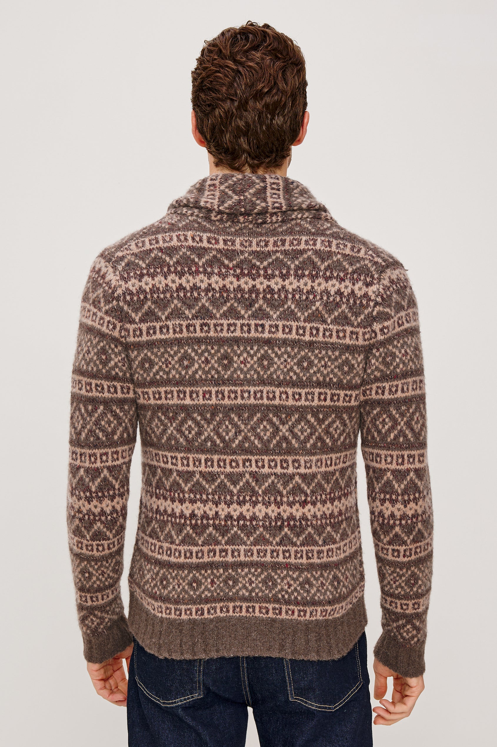 Kallio is a button front cardigan with a lapel in Amiata Farisle. Back view featured on model.